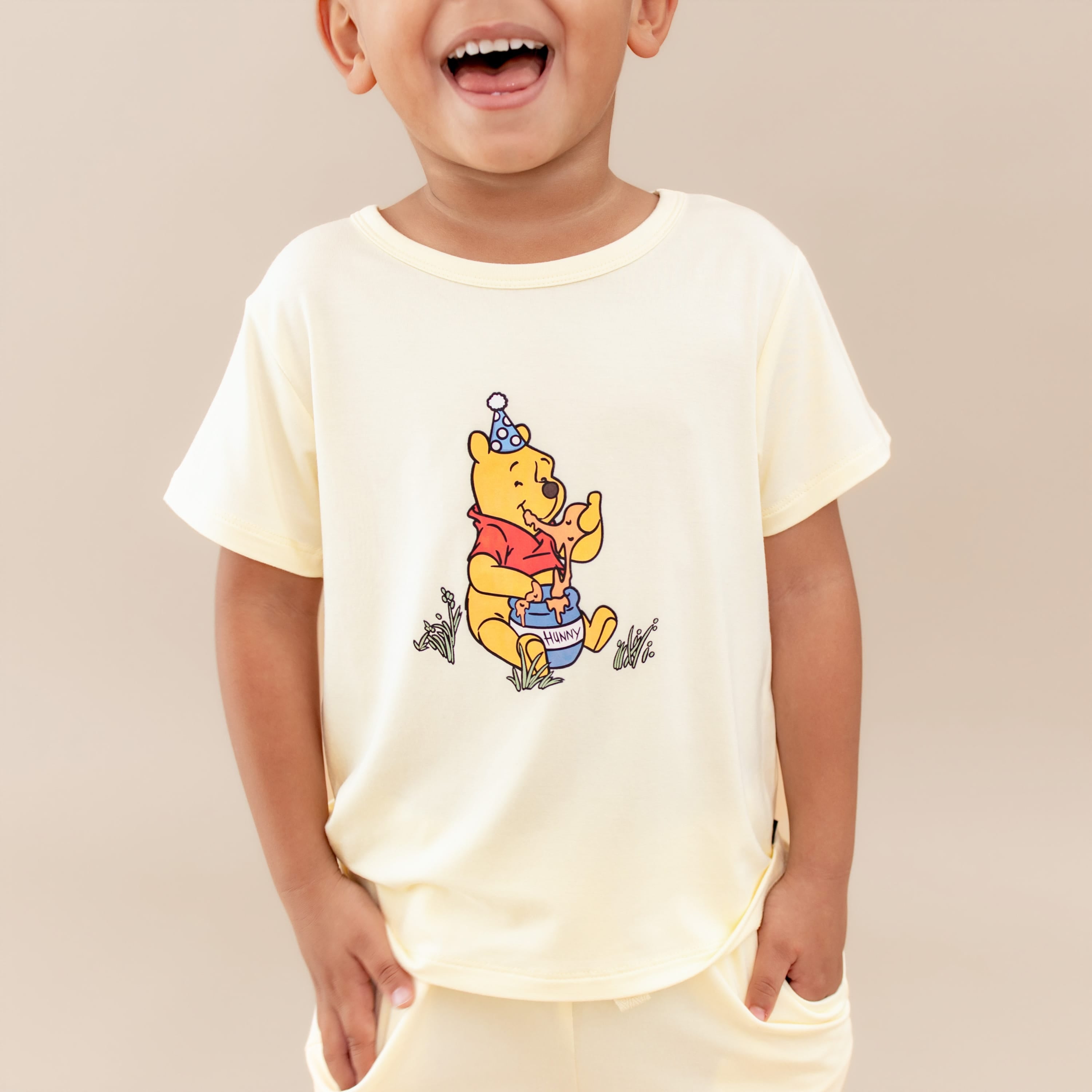 Close up of the Toddler Basic Tee in Winnie the Pooh on Chamomile shown in a young boy