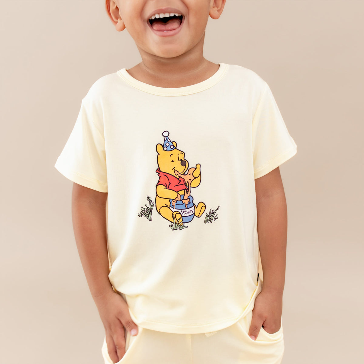 Close up of the Toddler Basic Tee in Winnie the Pooh on Chamomile shown in a young boy