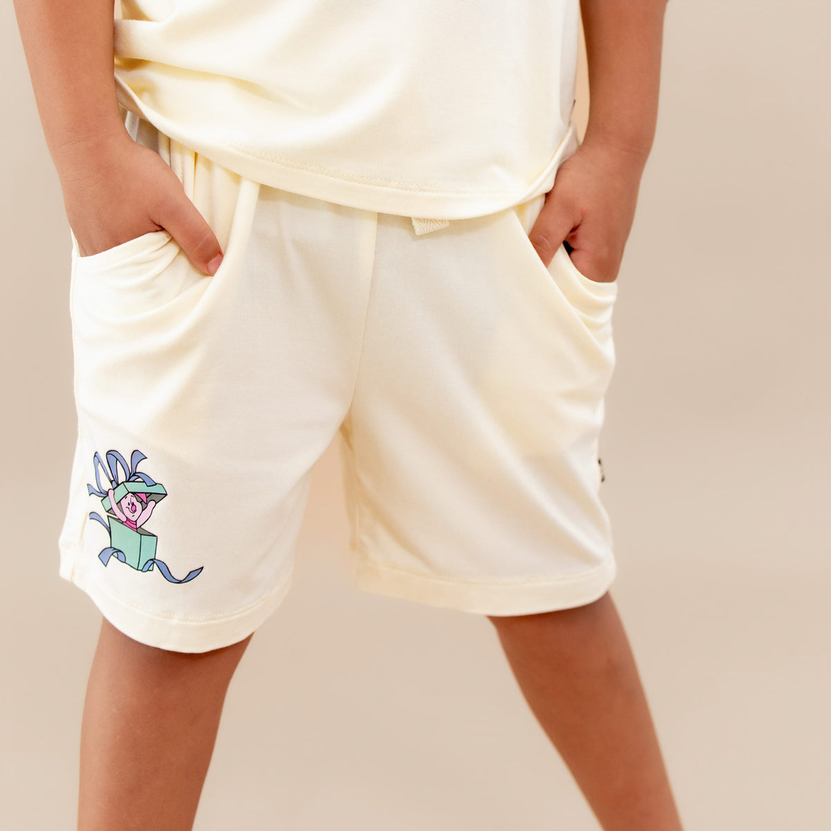 The Drawstring Short in Winnie the Pooh on Chamomile shown on a model
