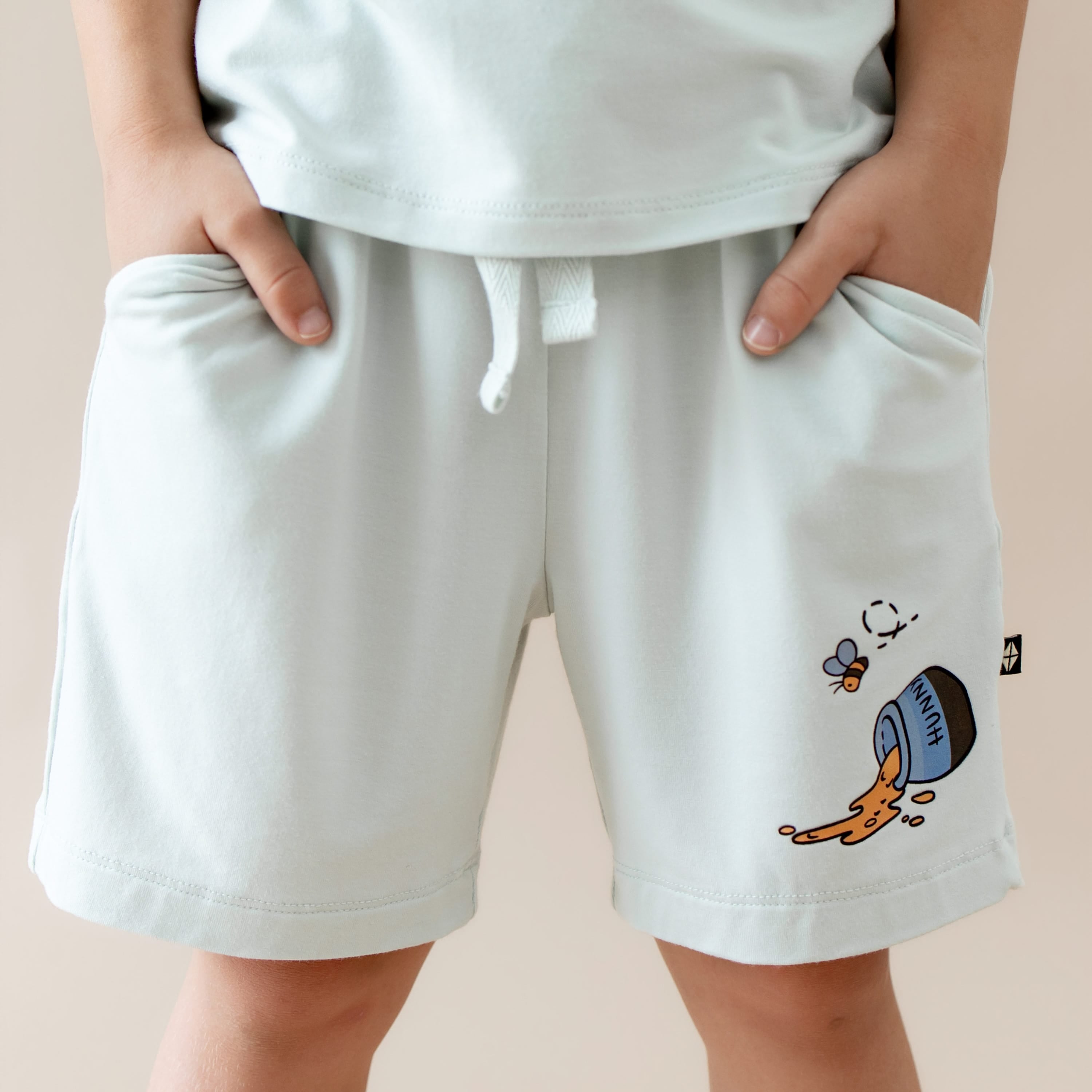 Close up of the Drawstring Short in Winnie the Pooh on Dew shown on a model