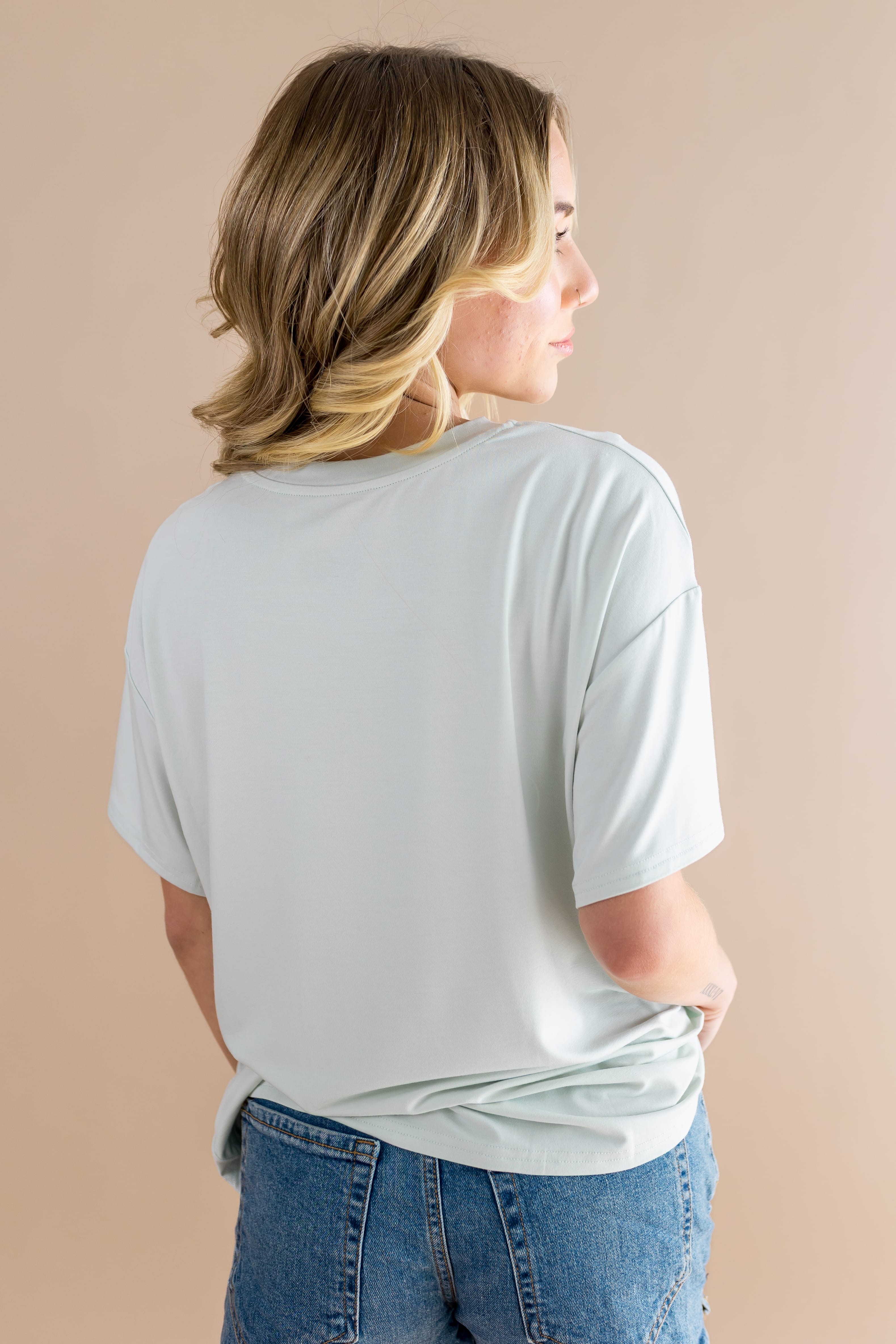 The back of the Women's Graphic Tee in Winnie the Pooh on Dew
showing the light green shirt on a female model