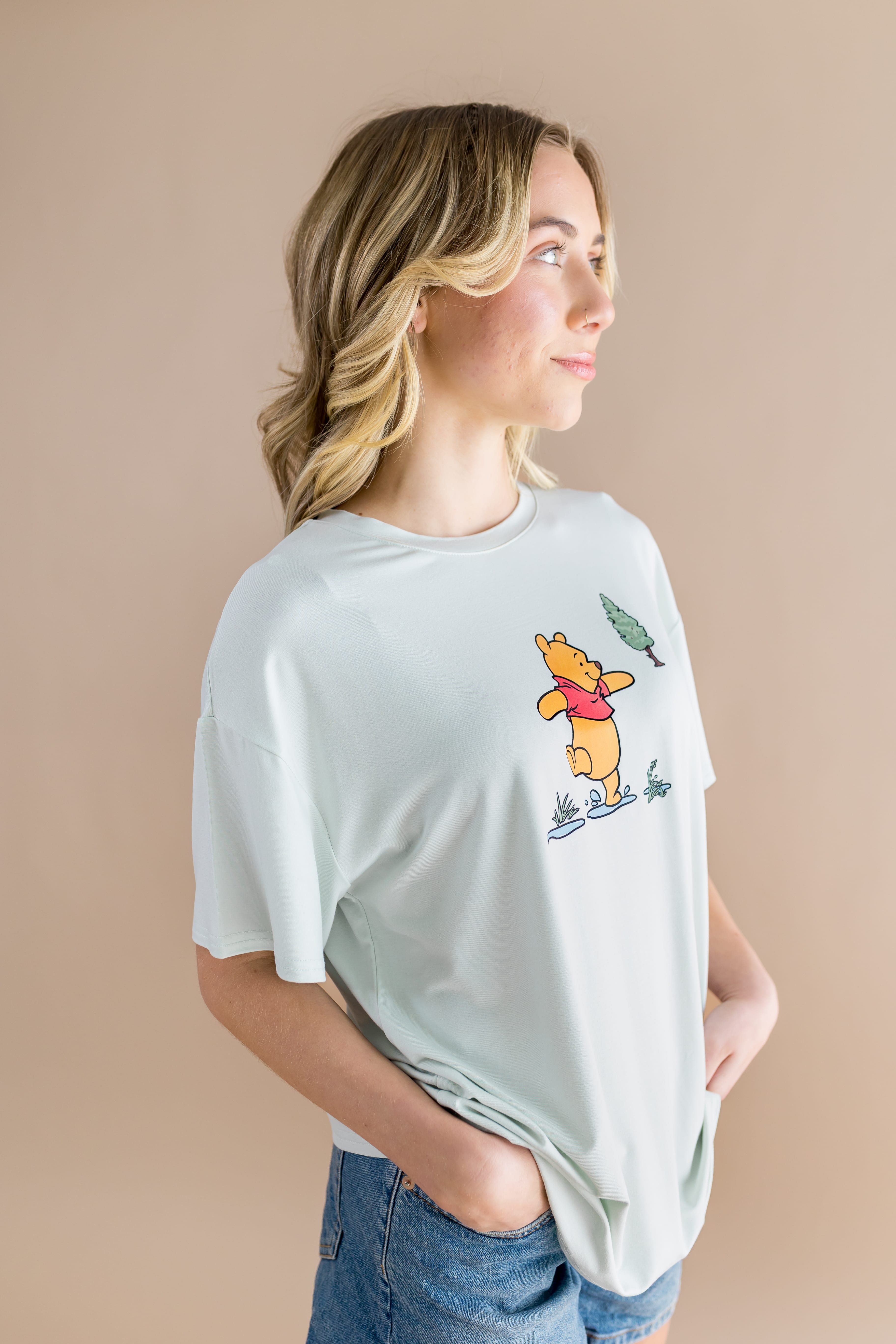 Side view of the Women's Graphic Tee in Winnie the Pooh on Dew
shown on a female model