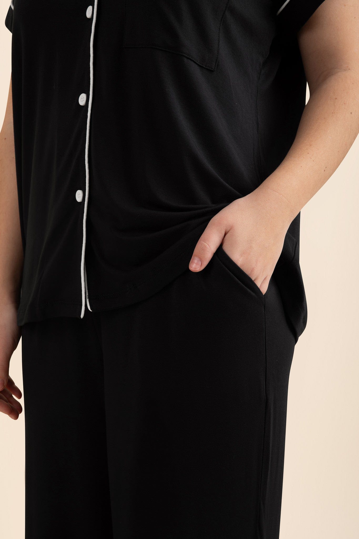 Close up of side pocket details on the pants of the Women's Short Sleeve Cropped Pajama Set in Midnight shown on a model