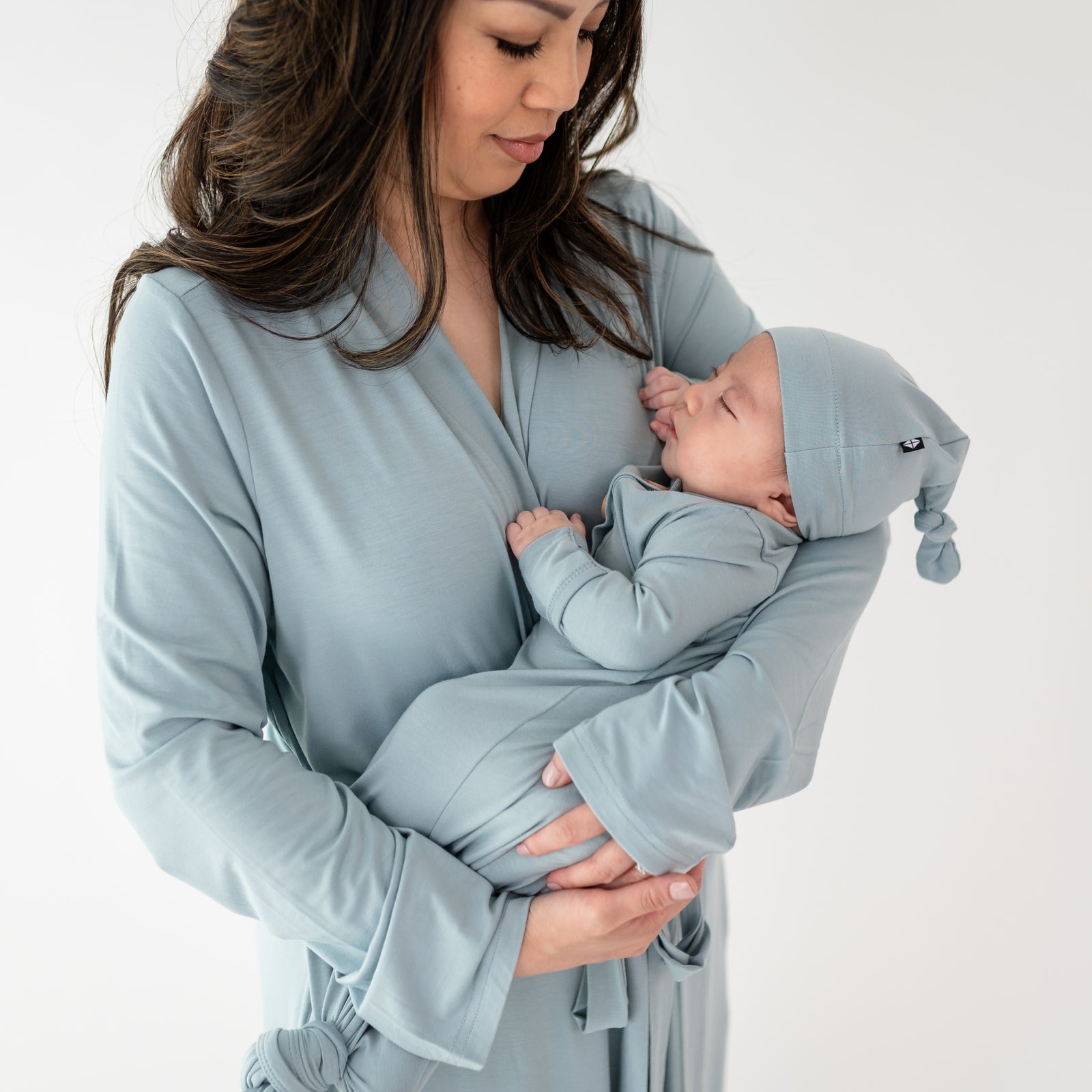 Mom in Fog lounge robe holding baby in fog knotted gown