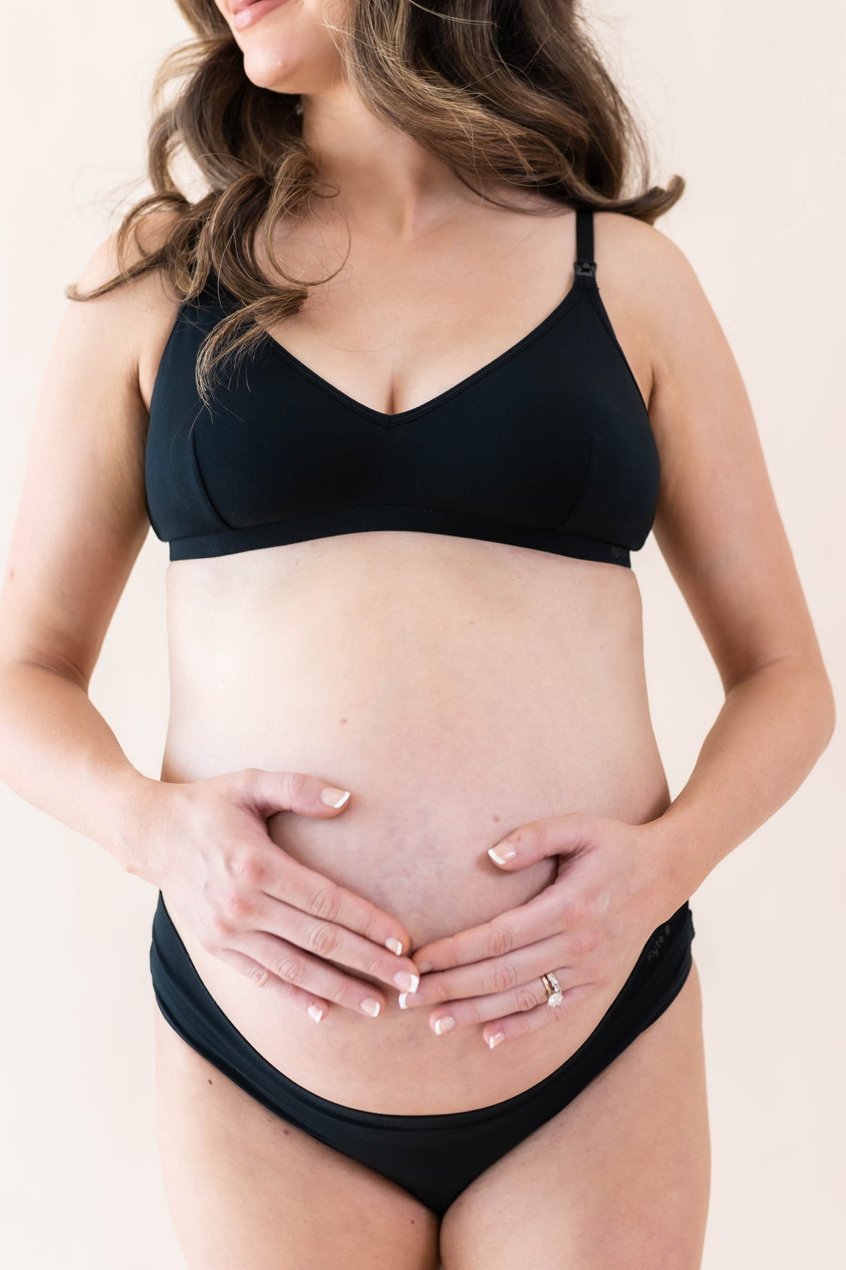 Expectant mother wearing the Women's Nursing Bra in Midnight