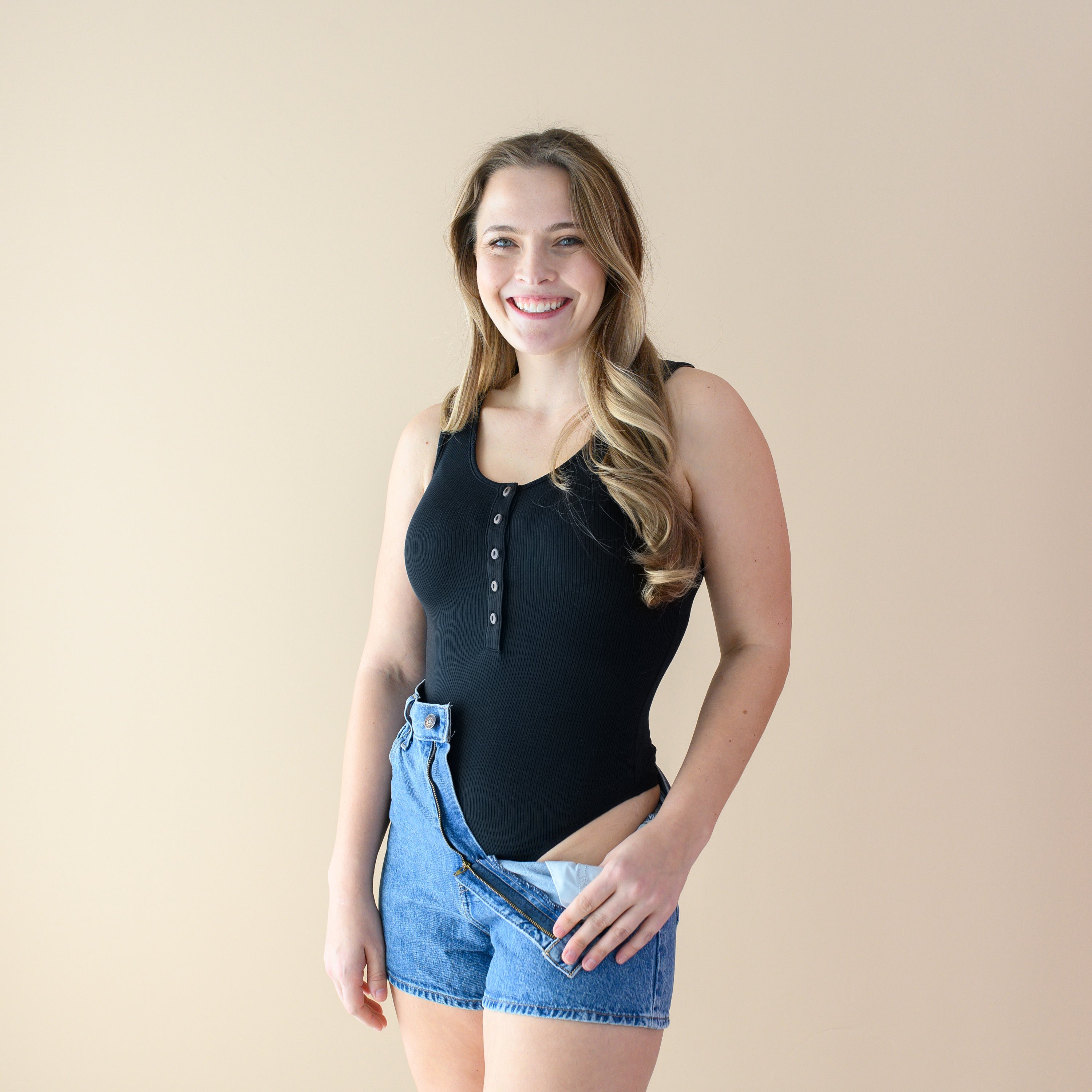 Woman wearing Women’s Ribbed Henley Thong Bodysuit in Midnight