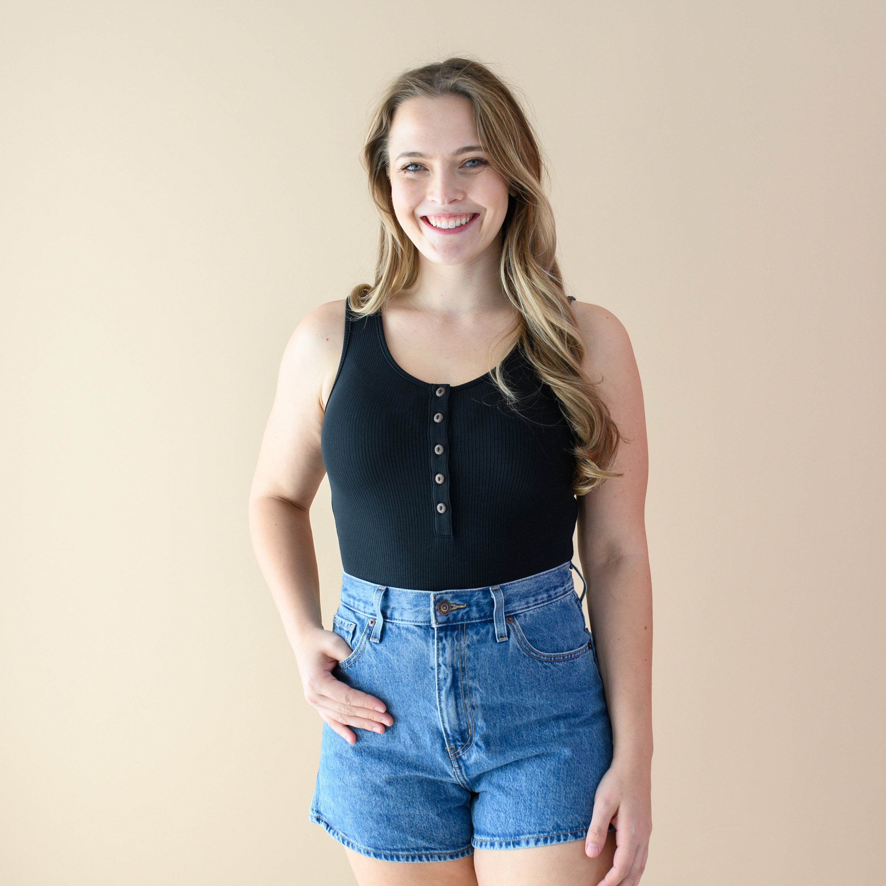 Woman wearing Women’s Ribbed Henley Bodysuit in Midnight