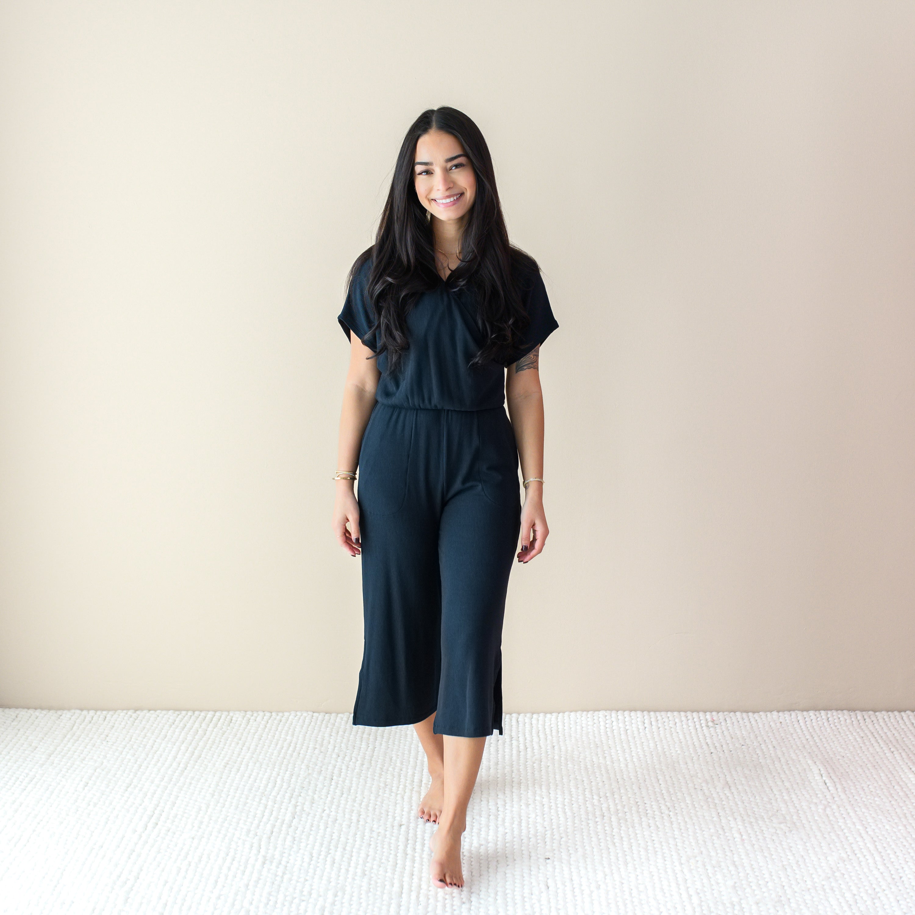 Woman wearing Black Ribbed Jumpsuit with Wide Leg