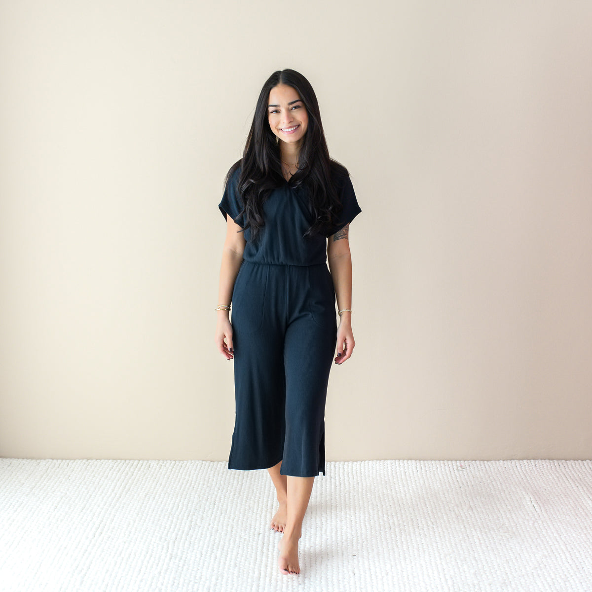 Woman wearing Black Ribbed Jumpsuit with Wide Leg