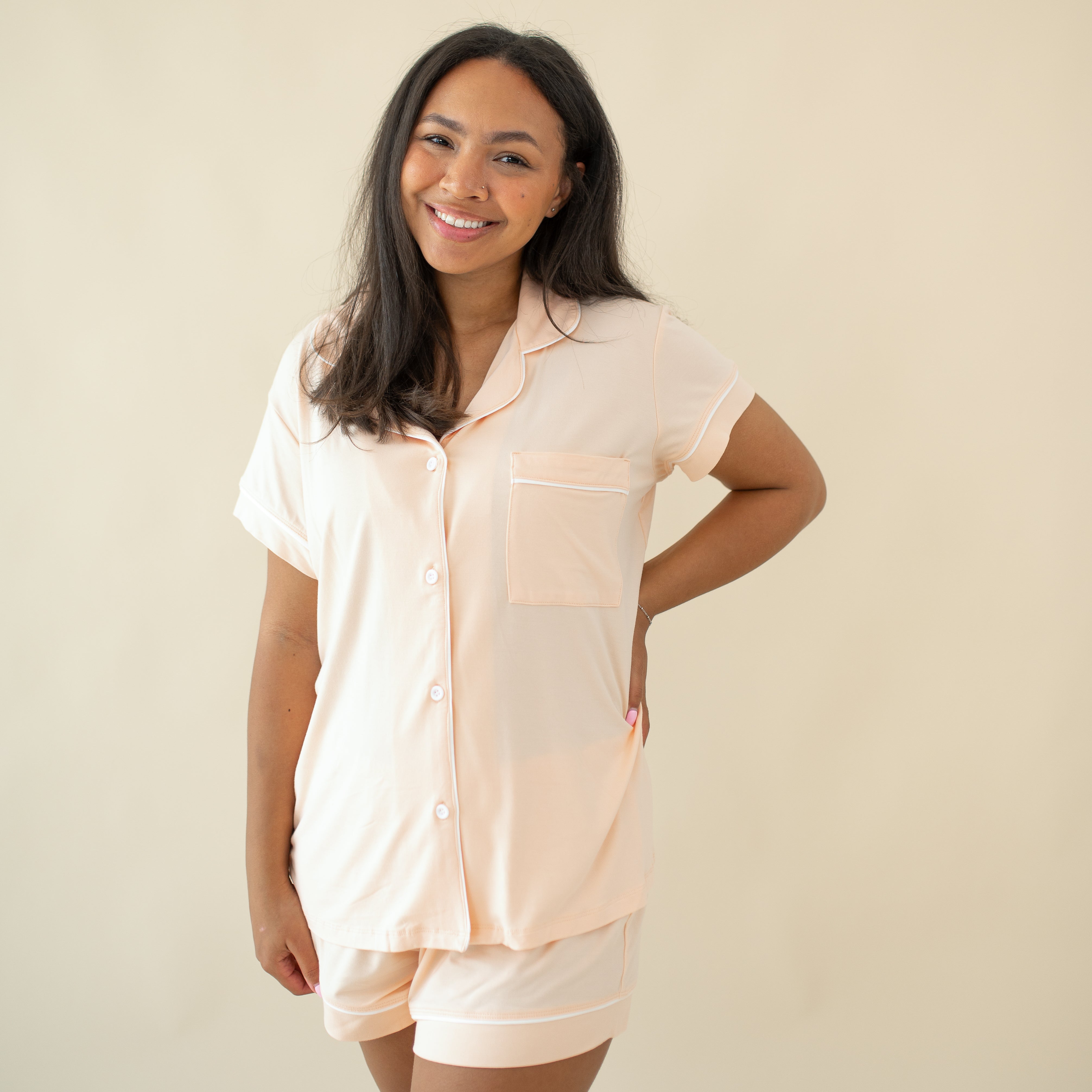Smiling female model wearing the Women's Short Sleeve Pajama Set in Canyon with one hand on hip