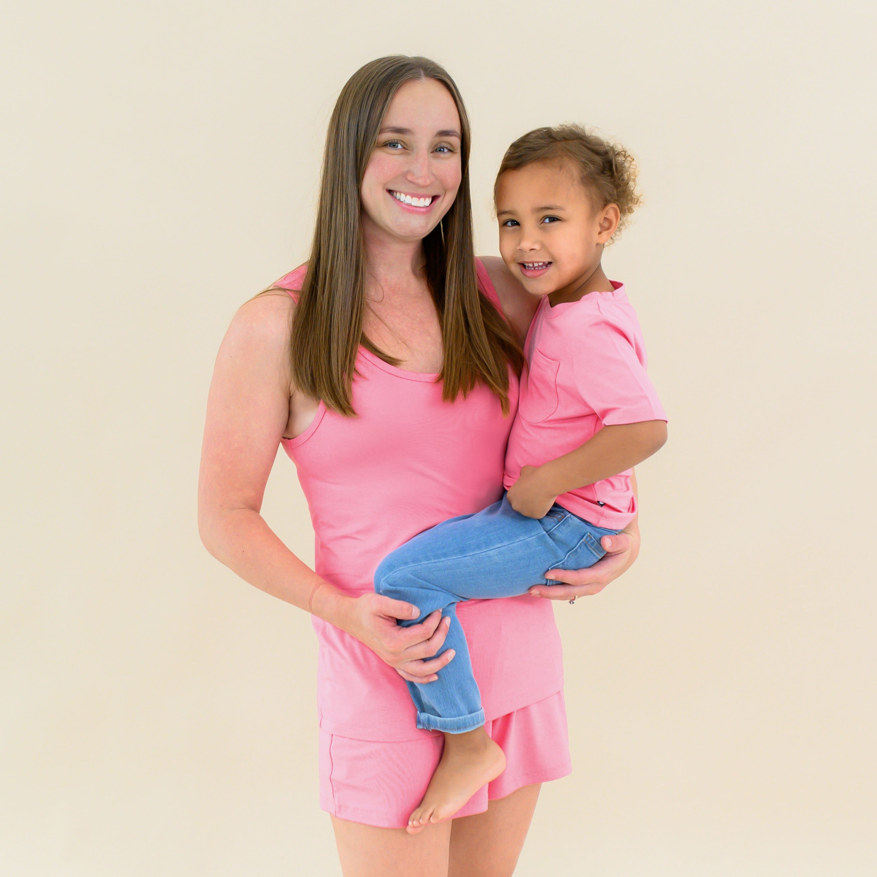 Mom holding child in matching Guava pink Mommy and Me outfits