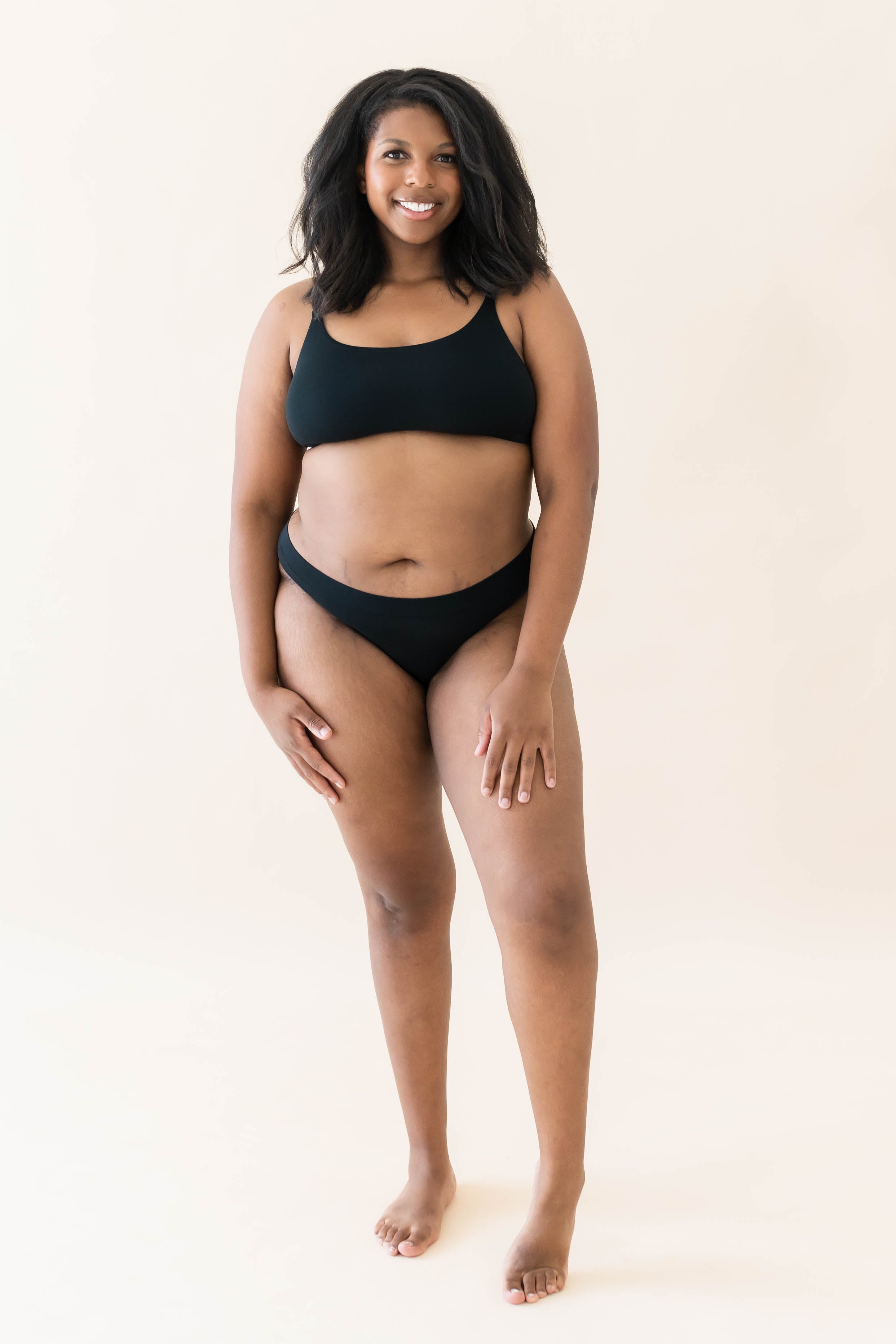 Female modeling the Women's Thong in Midnight and matching scoop neck bralette