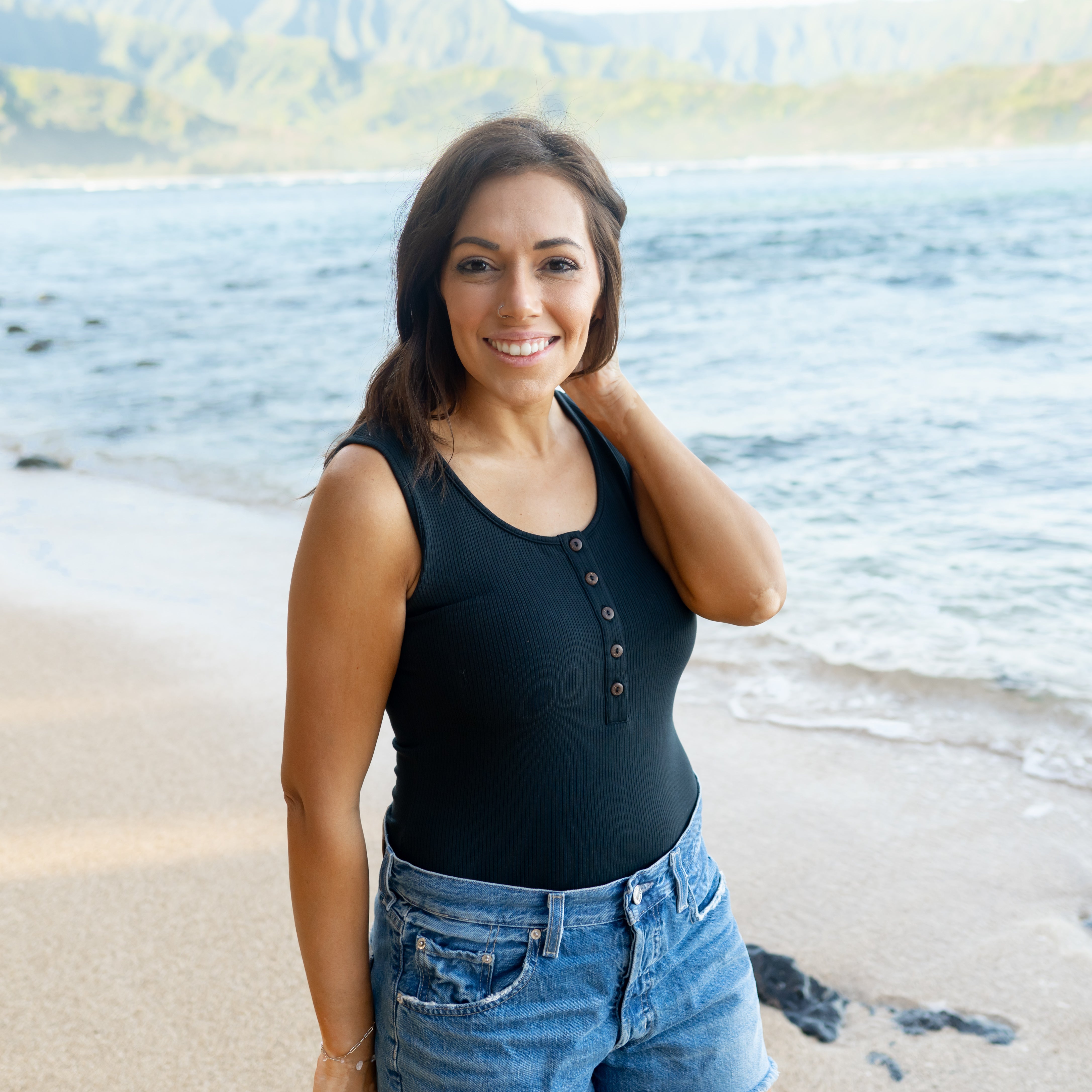 Woman wearing Women’s Ribbed Henley Tank Bodysuit in Midnight Black