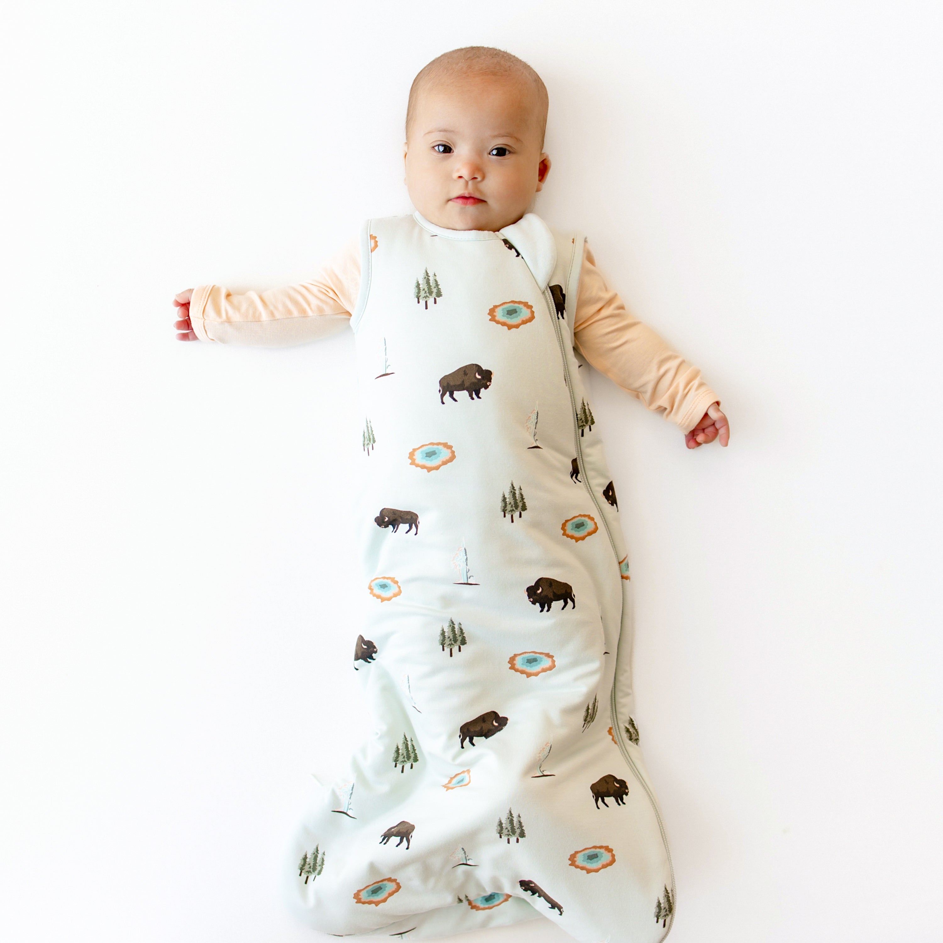 Baby modeling Sleep Bag in Yellowstone 1.0 and Canyon Footie