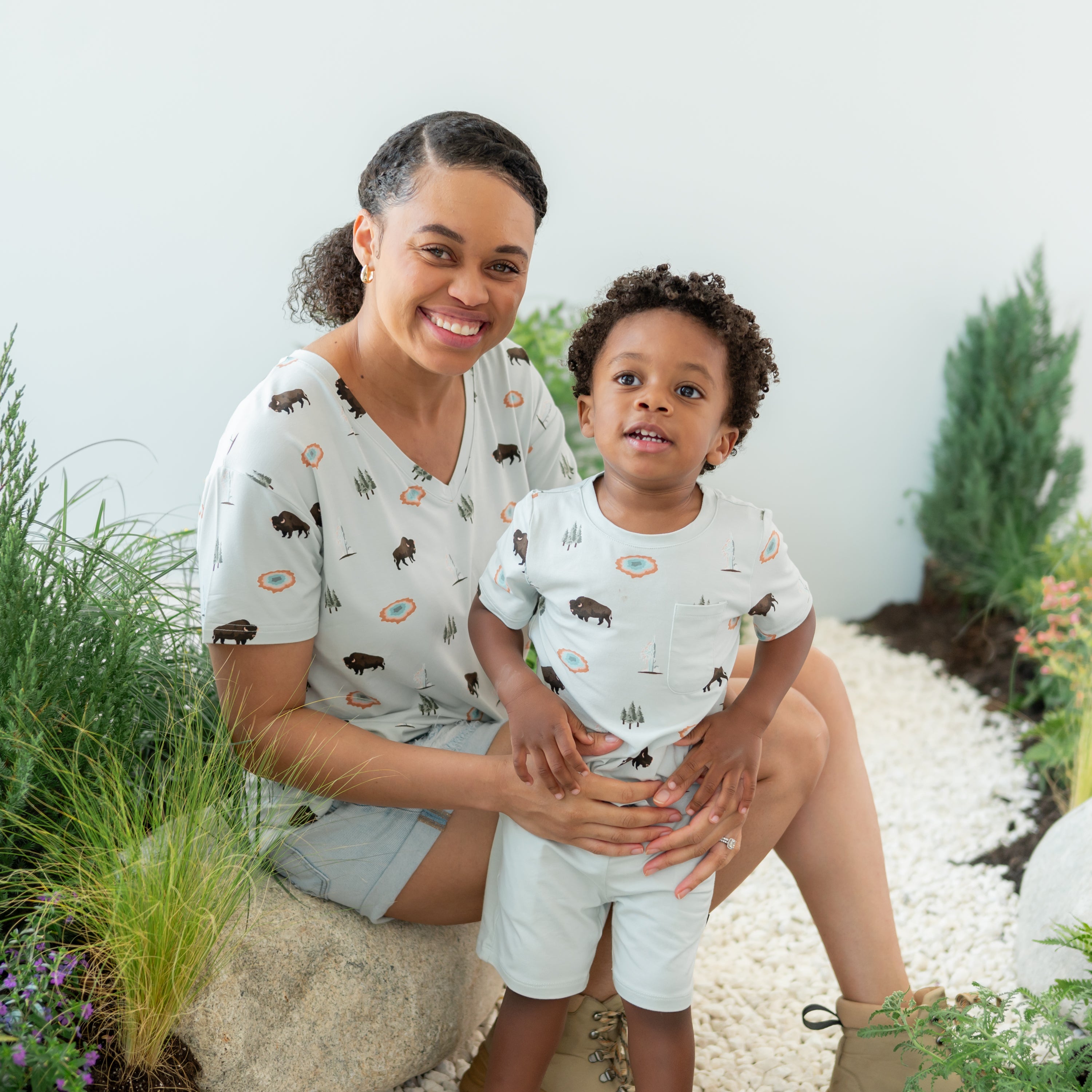 Toddler modeling Toddler Crew Neck Tee in Yellowstone with mom in matching V-Neck on a nature trail backdrop