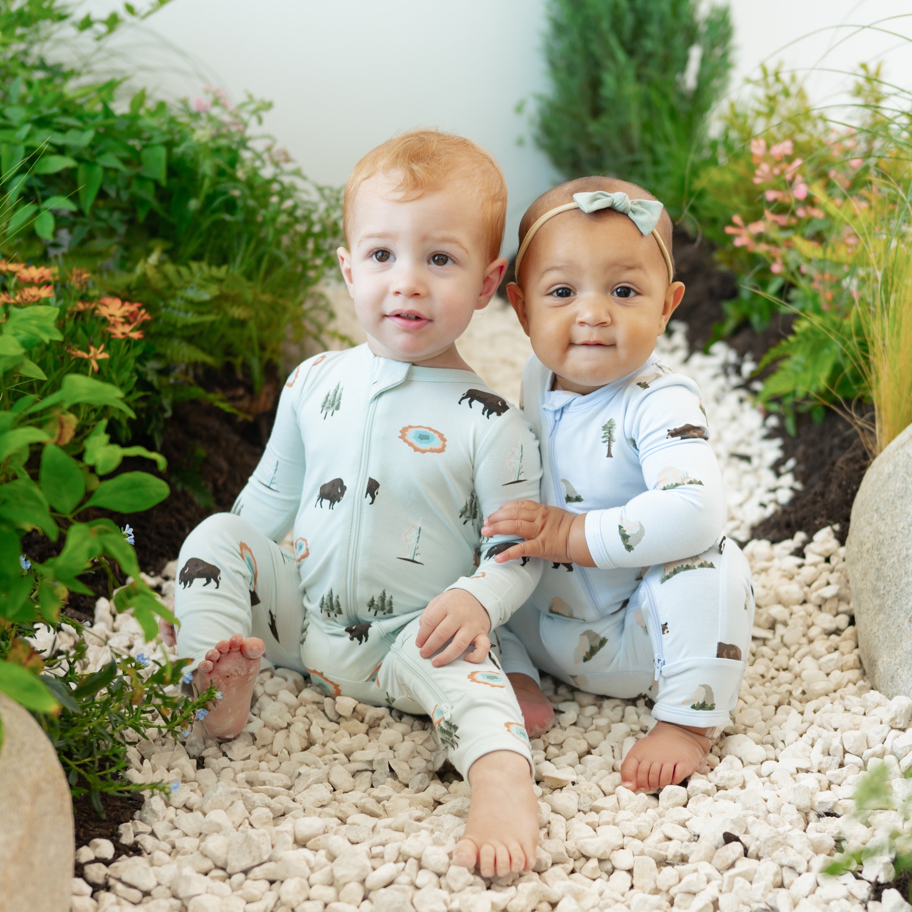 2 toddlers modeling Zippered Rompers in Yellowstone and Yosemite on nature trail