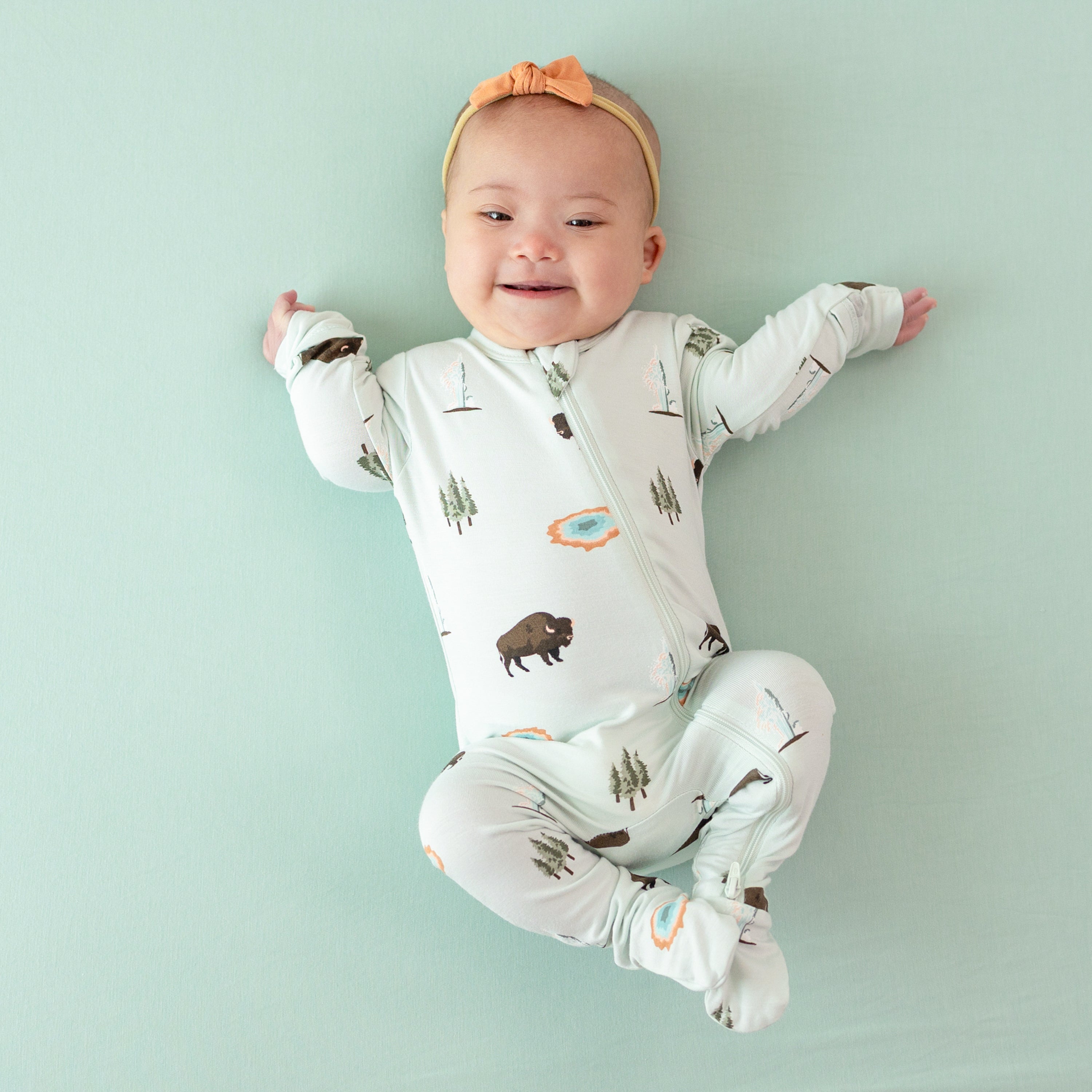 Baby wearing Zippered Footie in Yellowstone