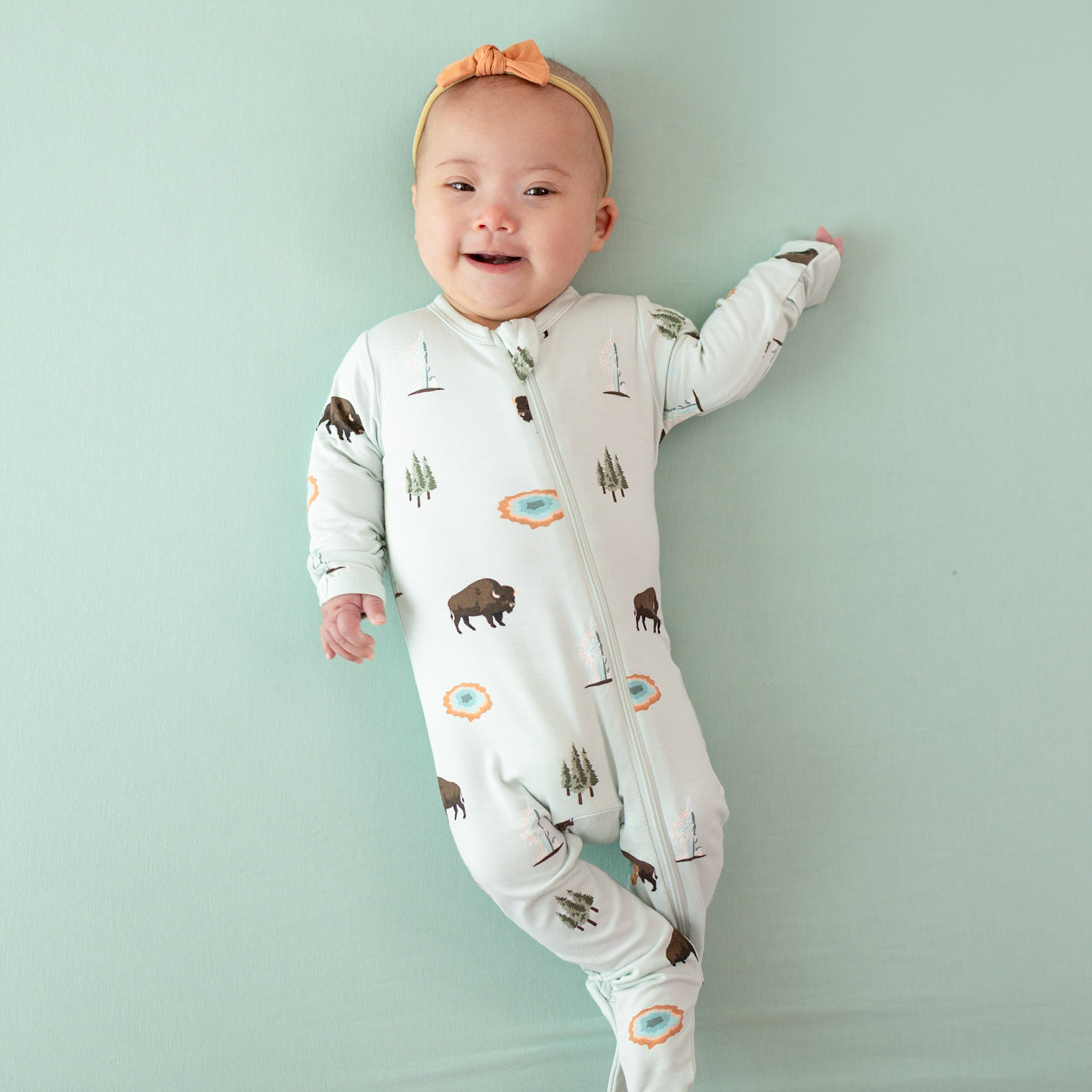 Baby wearing bamboo Zippered Footie pjs in Yellowstone