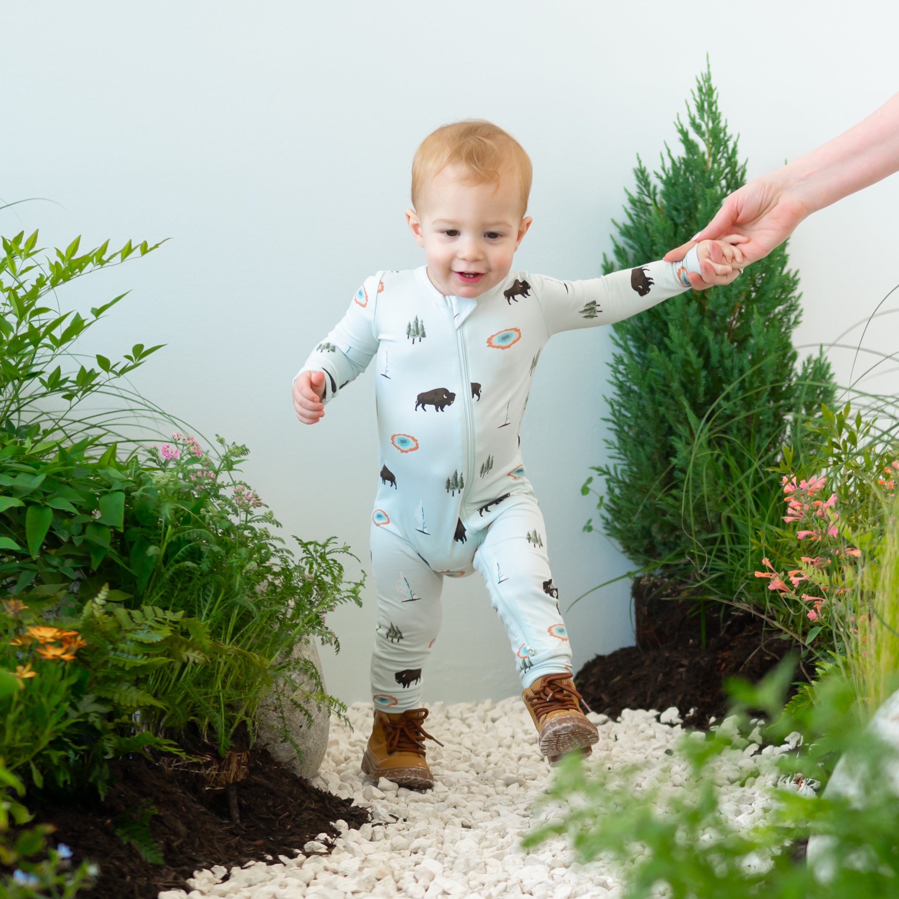 Toddler modeling Zippered Romper in Yellowstone on nature trail
