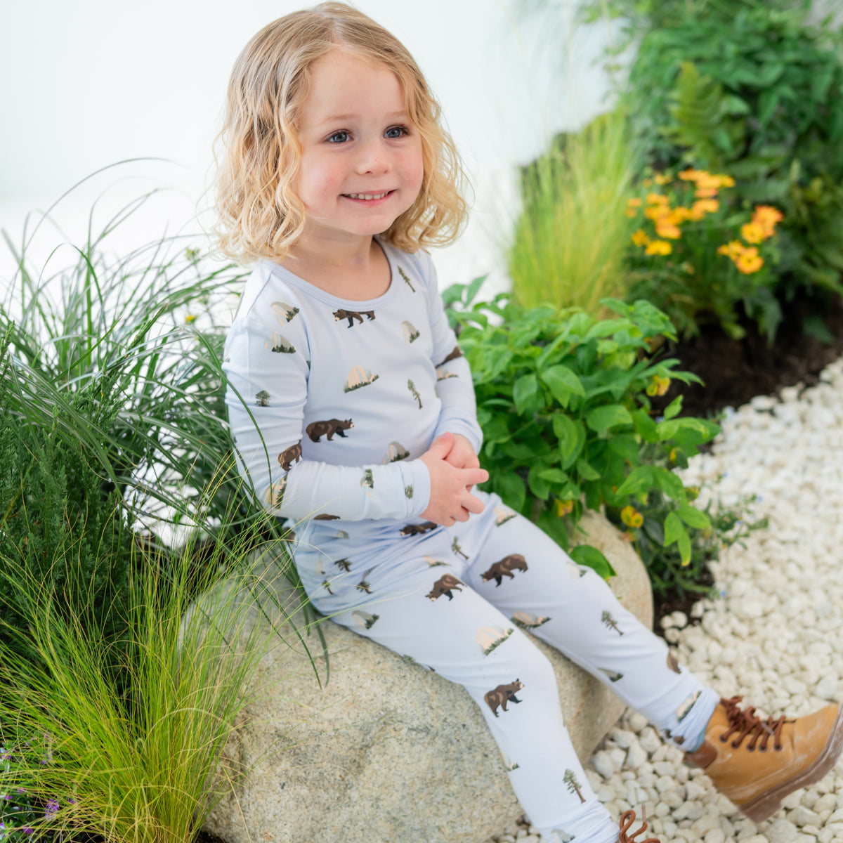 Toddler modeling Long Sleeve Pajamas in Yosemite sitting on a rock