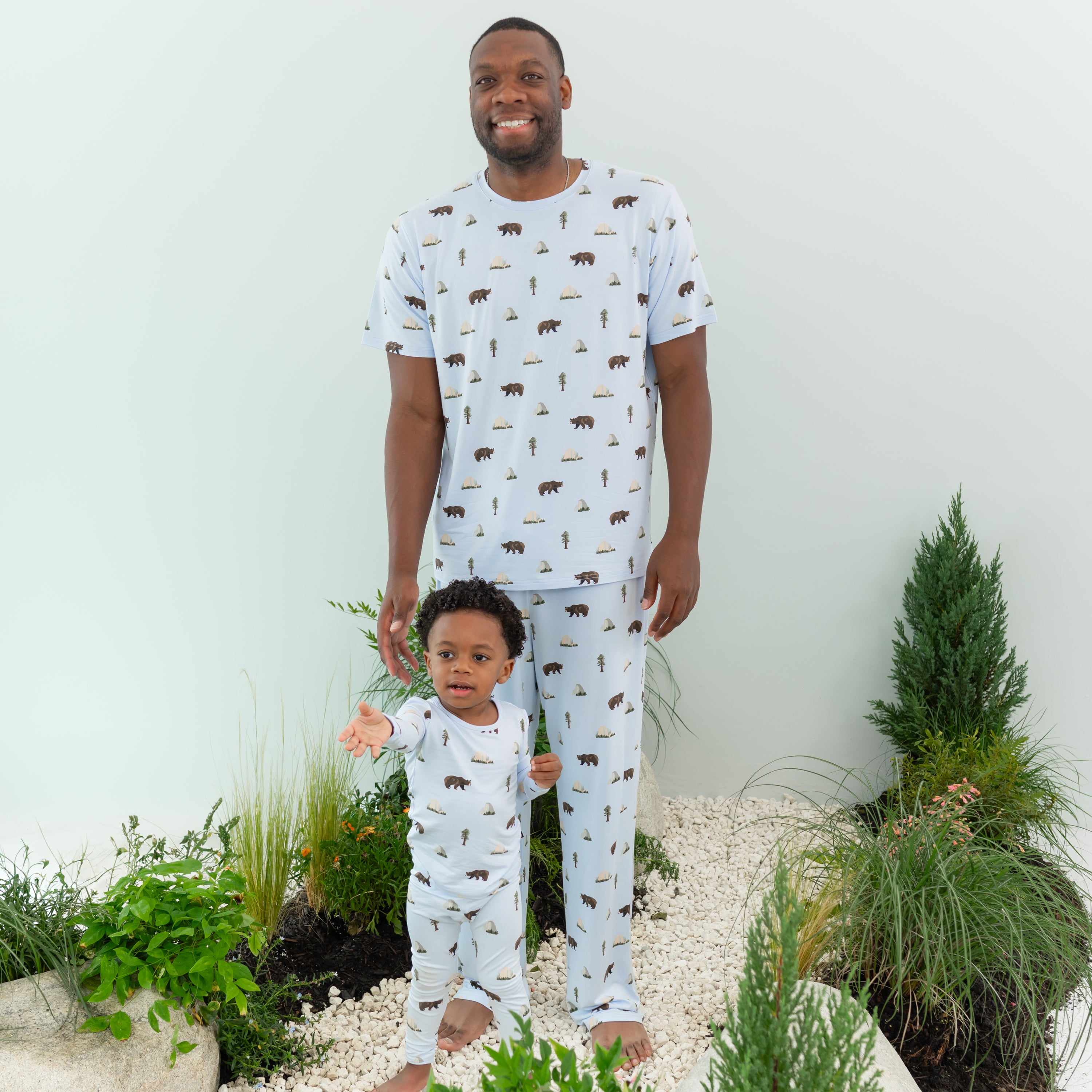 Man wearing Men's Crew Neck Tee in Yosemite and matching Lounge Pants with son wearing matching pajamas