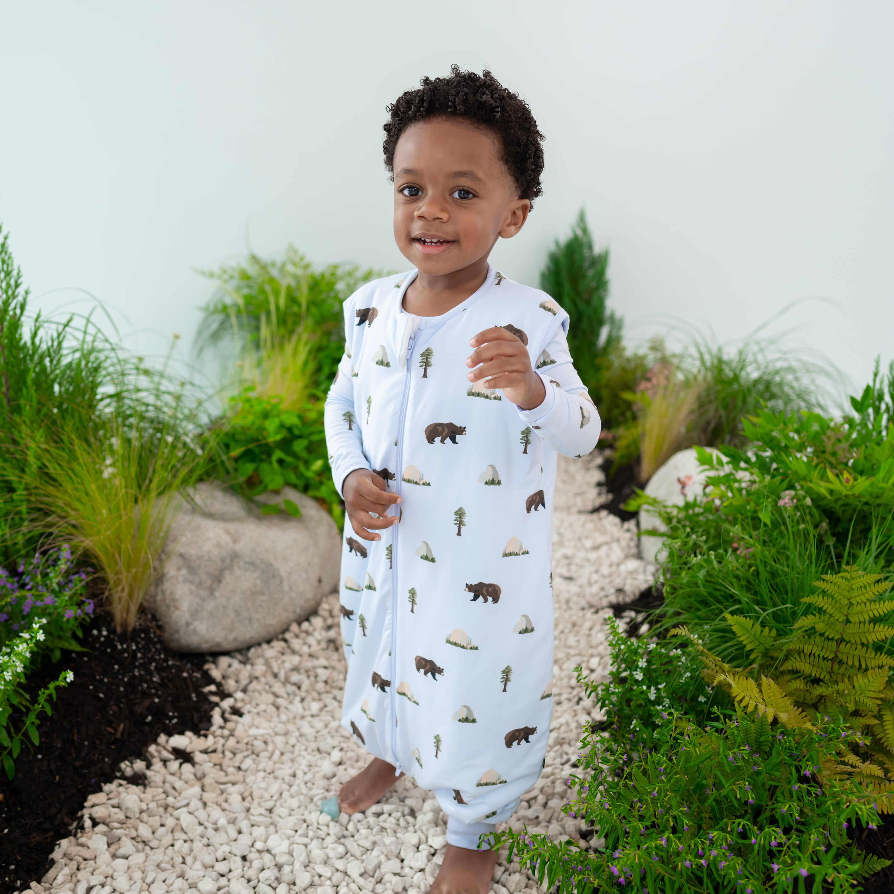 Toddler modeling Sleep Bag Walker in Yosemite 1.0 on a nature trail backdrop