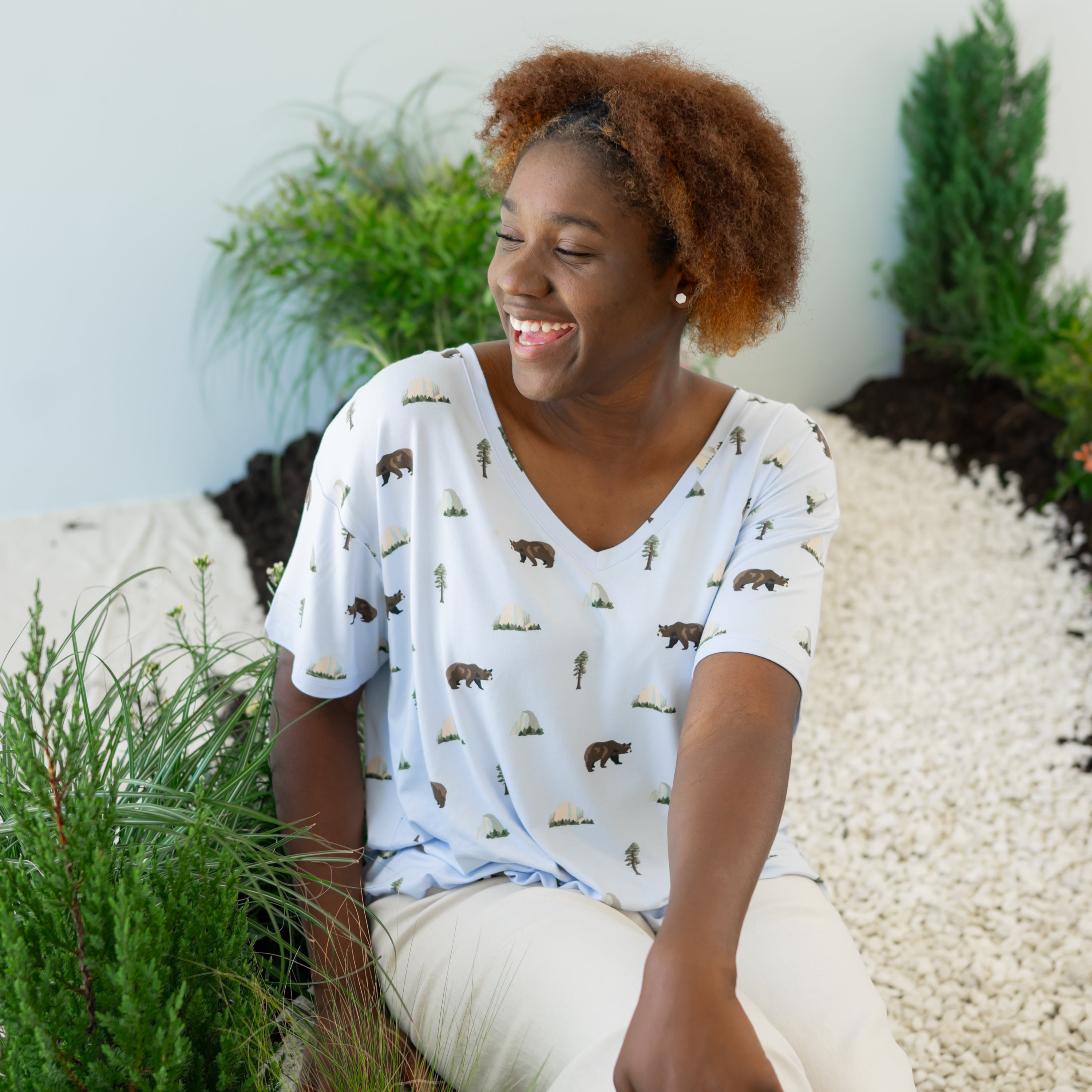Woman modeling Women's Relaxed Fit V-Neck in Yosemite sitting on nature trail
