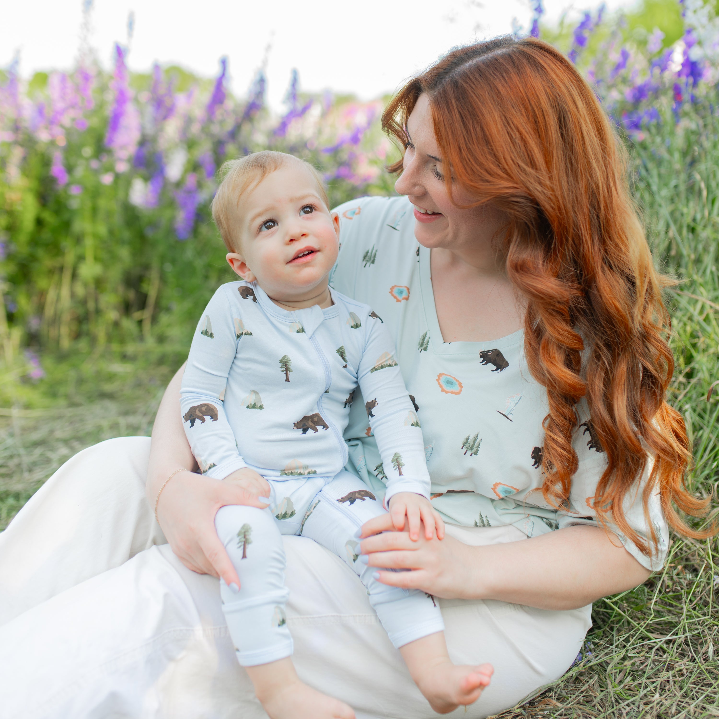Woman wearing Women's Relaxed Fit V-Neck in Yellowstone with toddler in Yosemite Zippered Romper in wildflower field