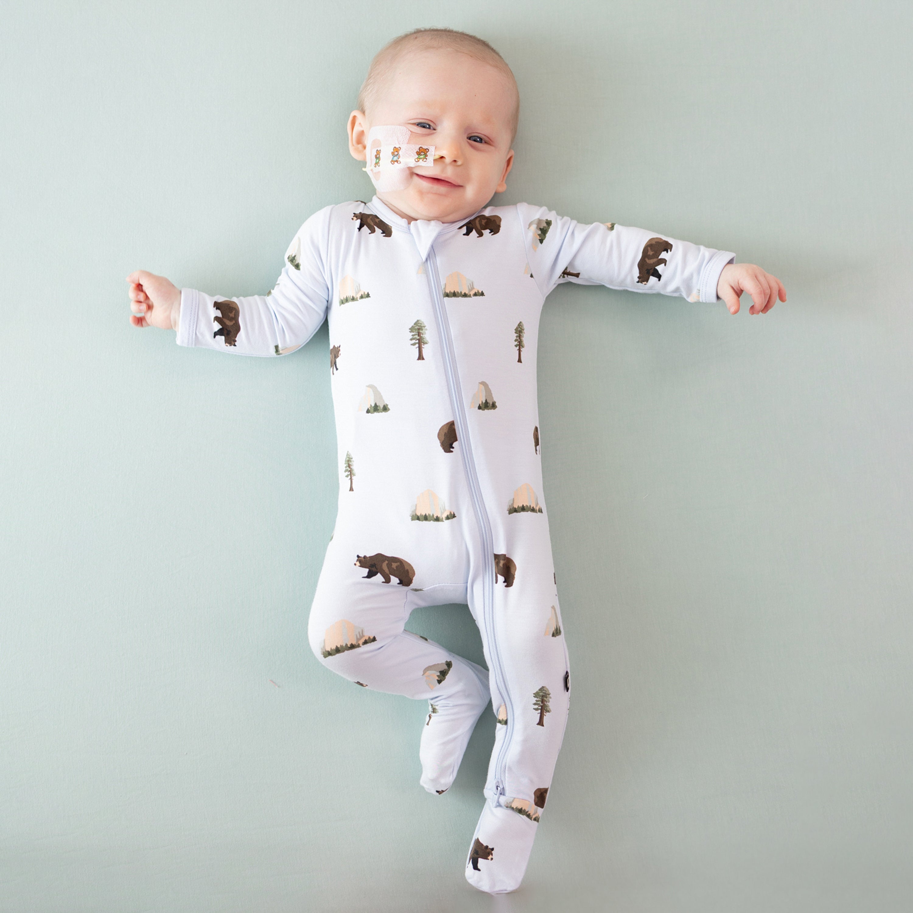 Baby wearing National Parks Zippered Footie in Yosemite