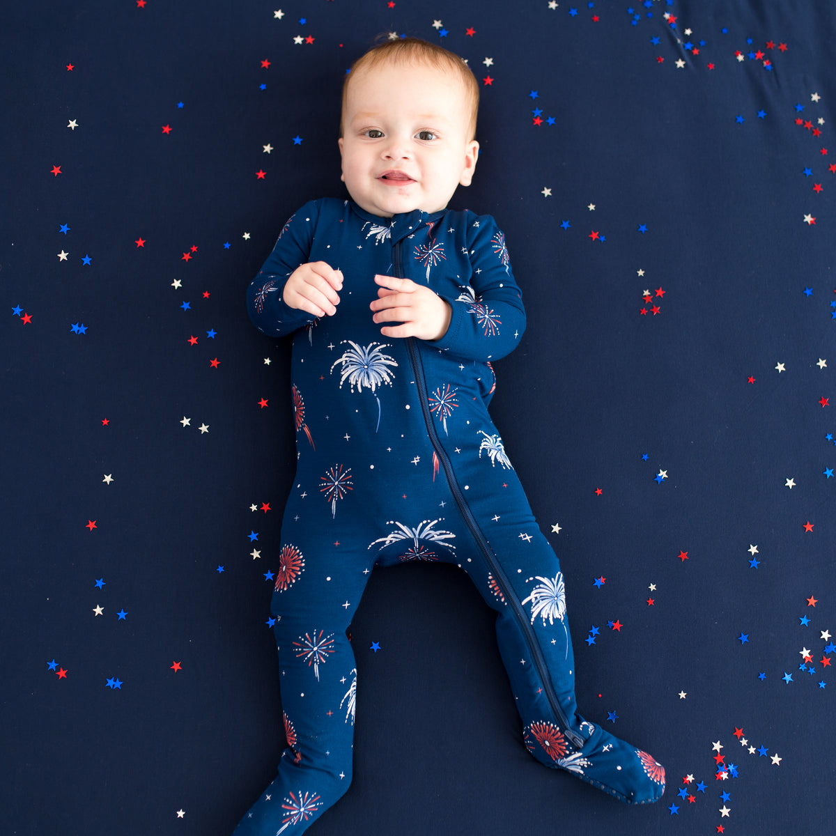 Baby wearing Zippered Footie in Celebration