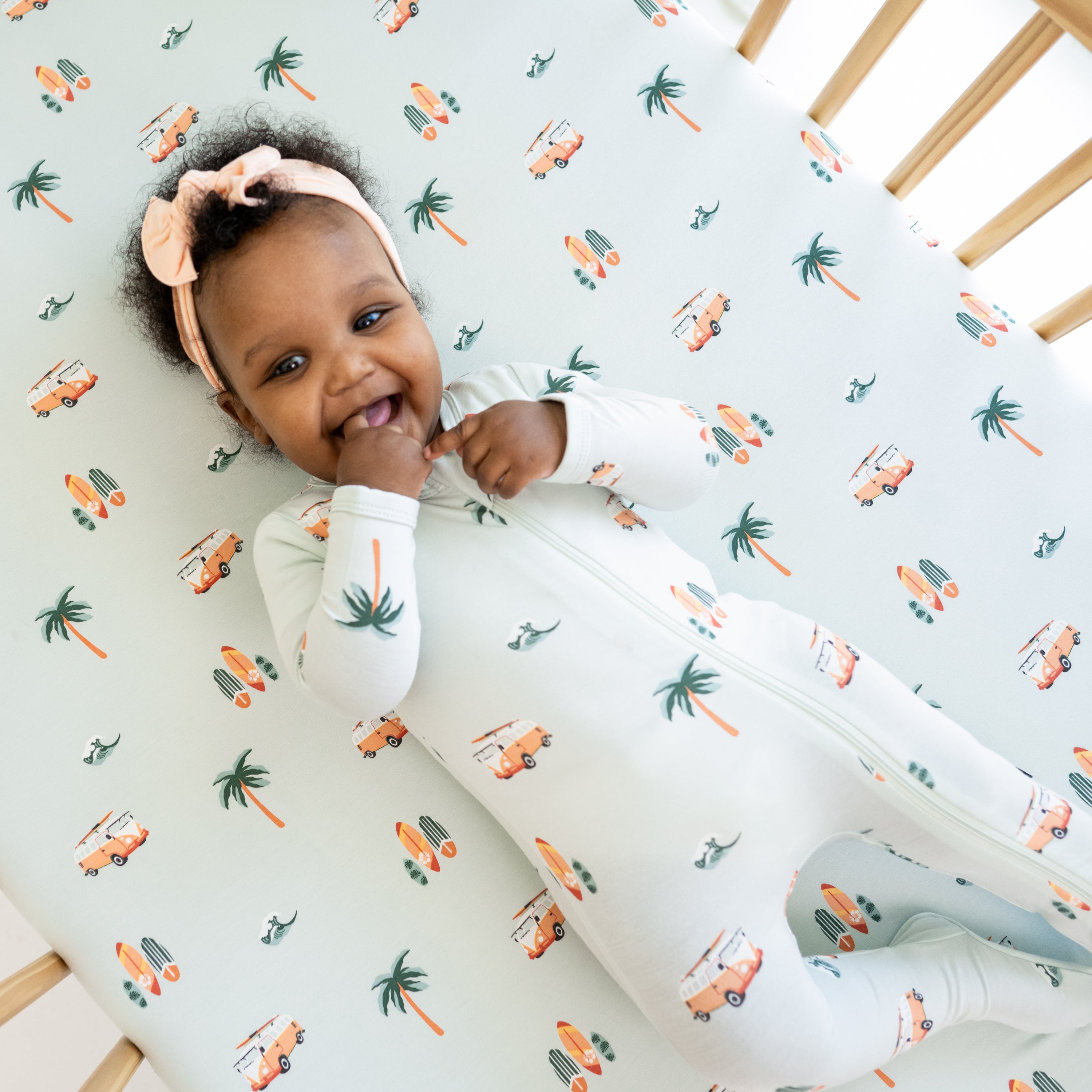 Close up of baby wearing Zippered Footie in Dew Surf