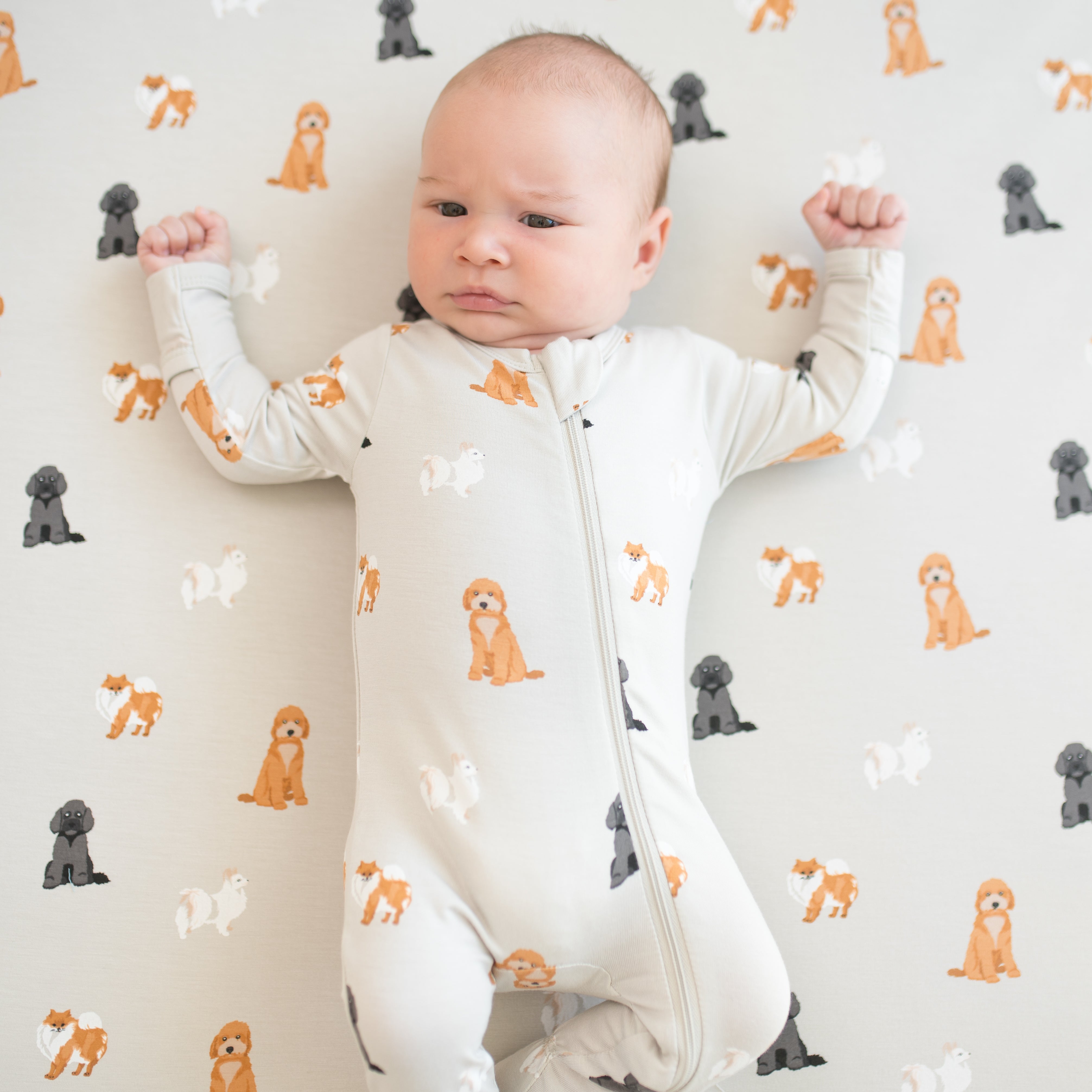 Close up of baby wearing Zippered Footie in Fluffy Dog