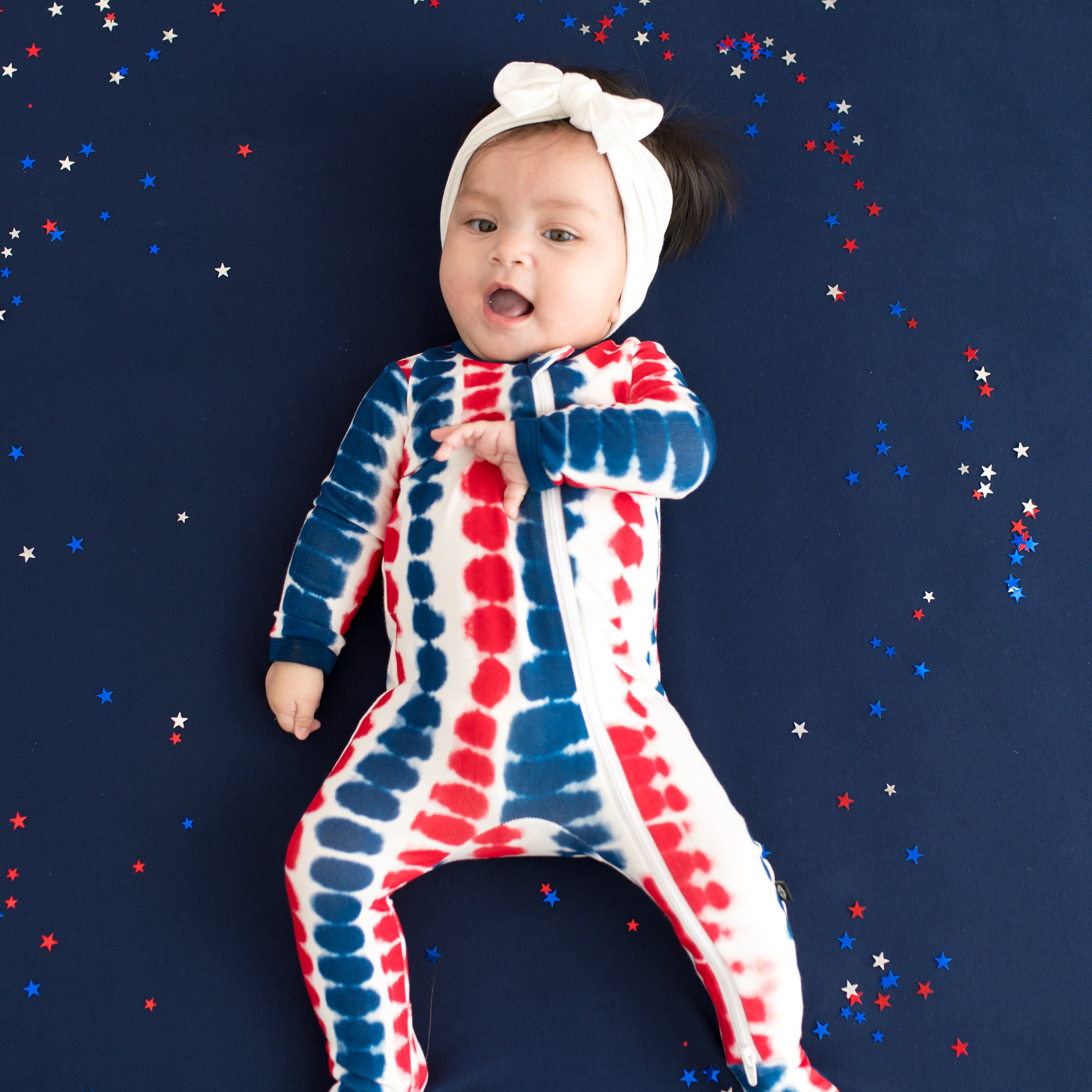 Close up on baby wearing Zippered Footie in Liberty Rip Tide
