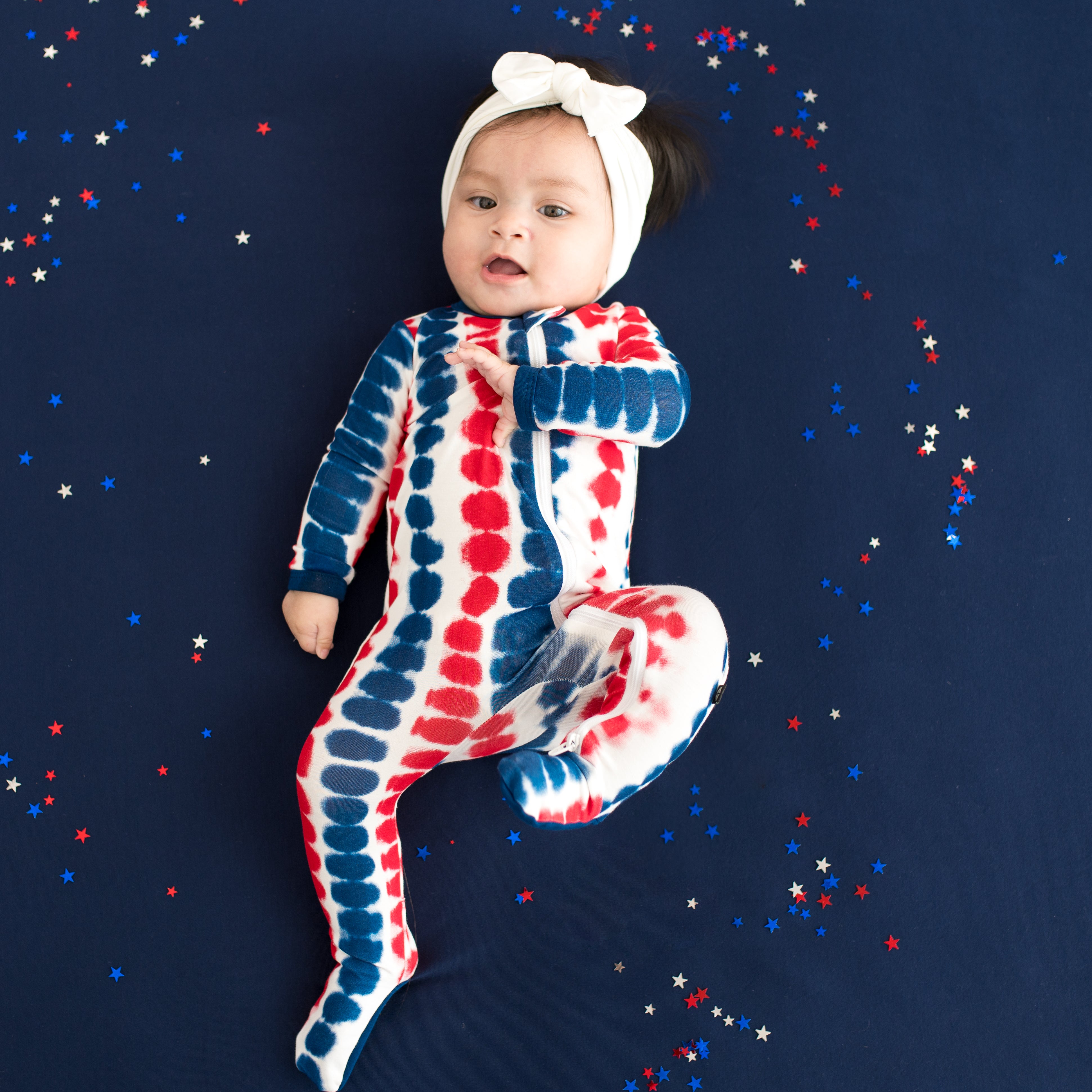 Baby wearing Zippered Footie in Liberty Rip Tide