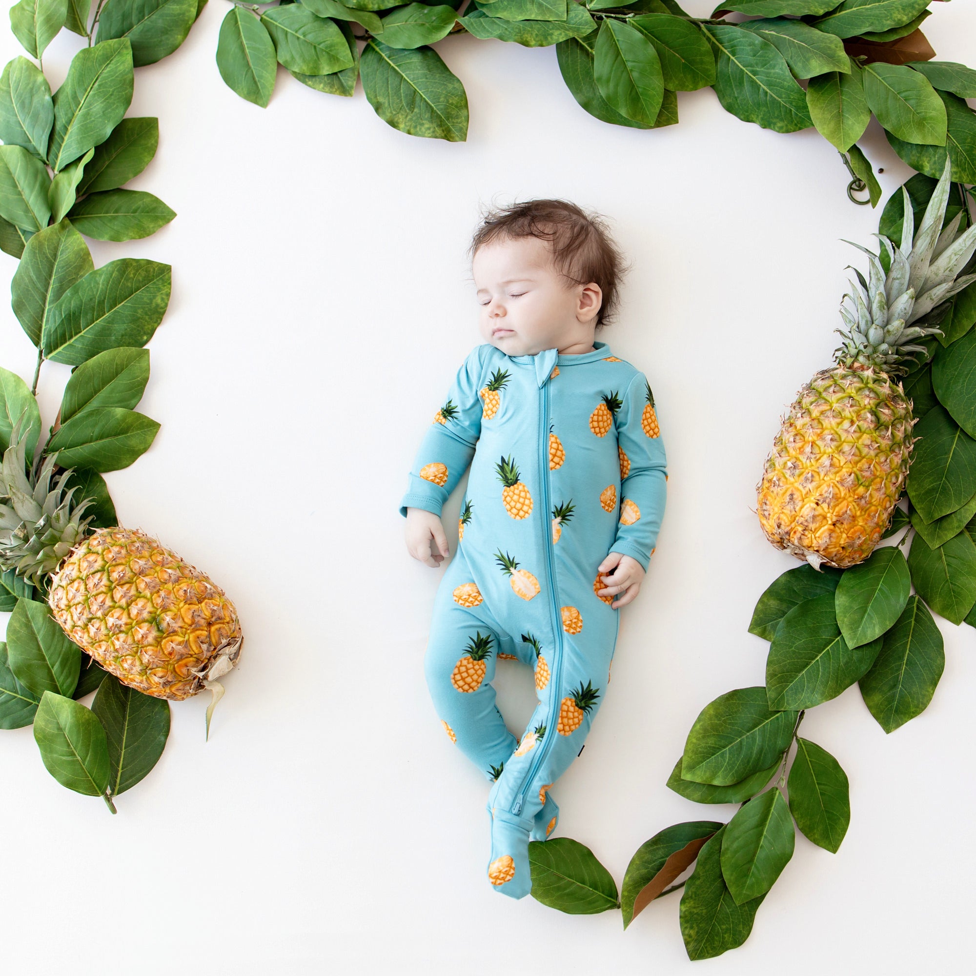 Baby sleeping in Zippered Footie in Pineapple