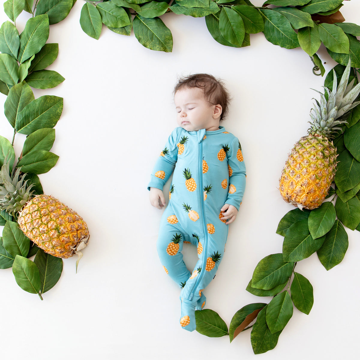Baby sleeping in Zippered Footie in Pineapple