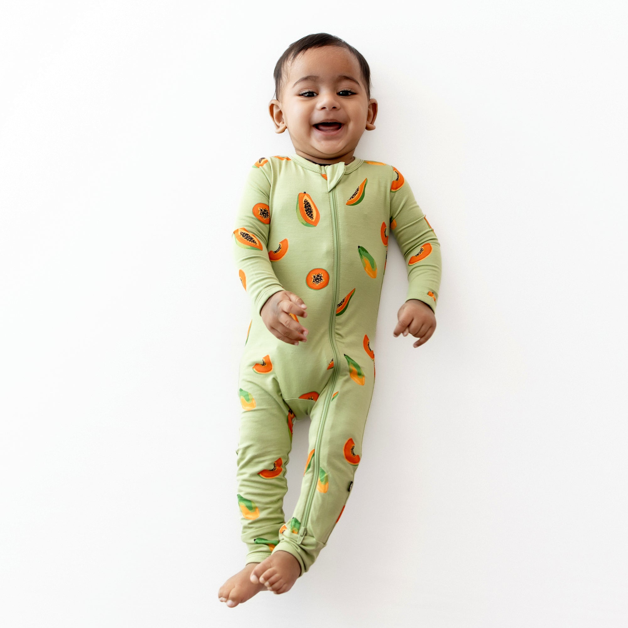 Baby smiling wearing Zippered Romper in Papaya