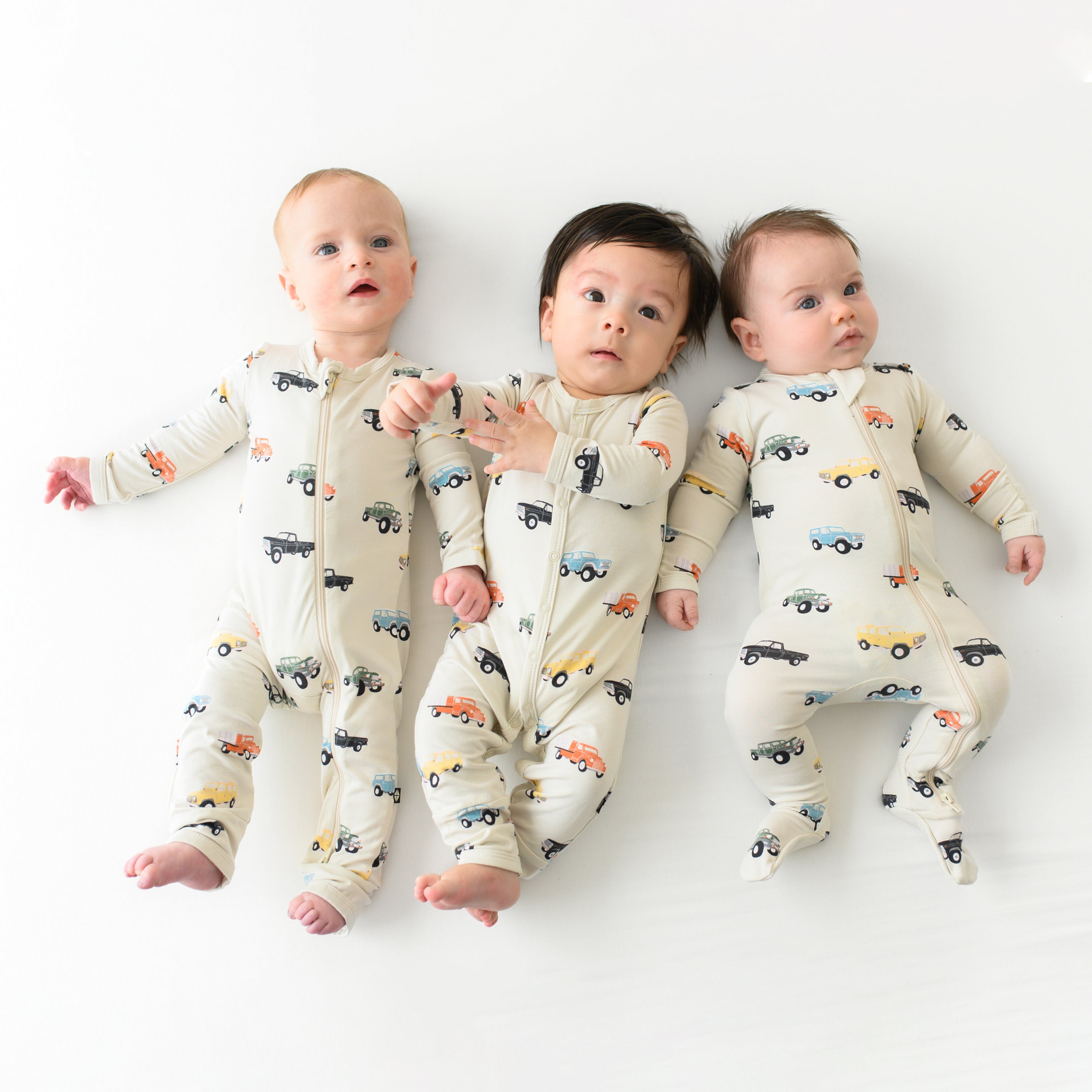 Babies wearing pajamas in Vintage Truck pattern