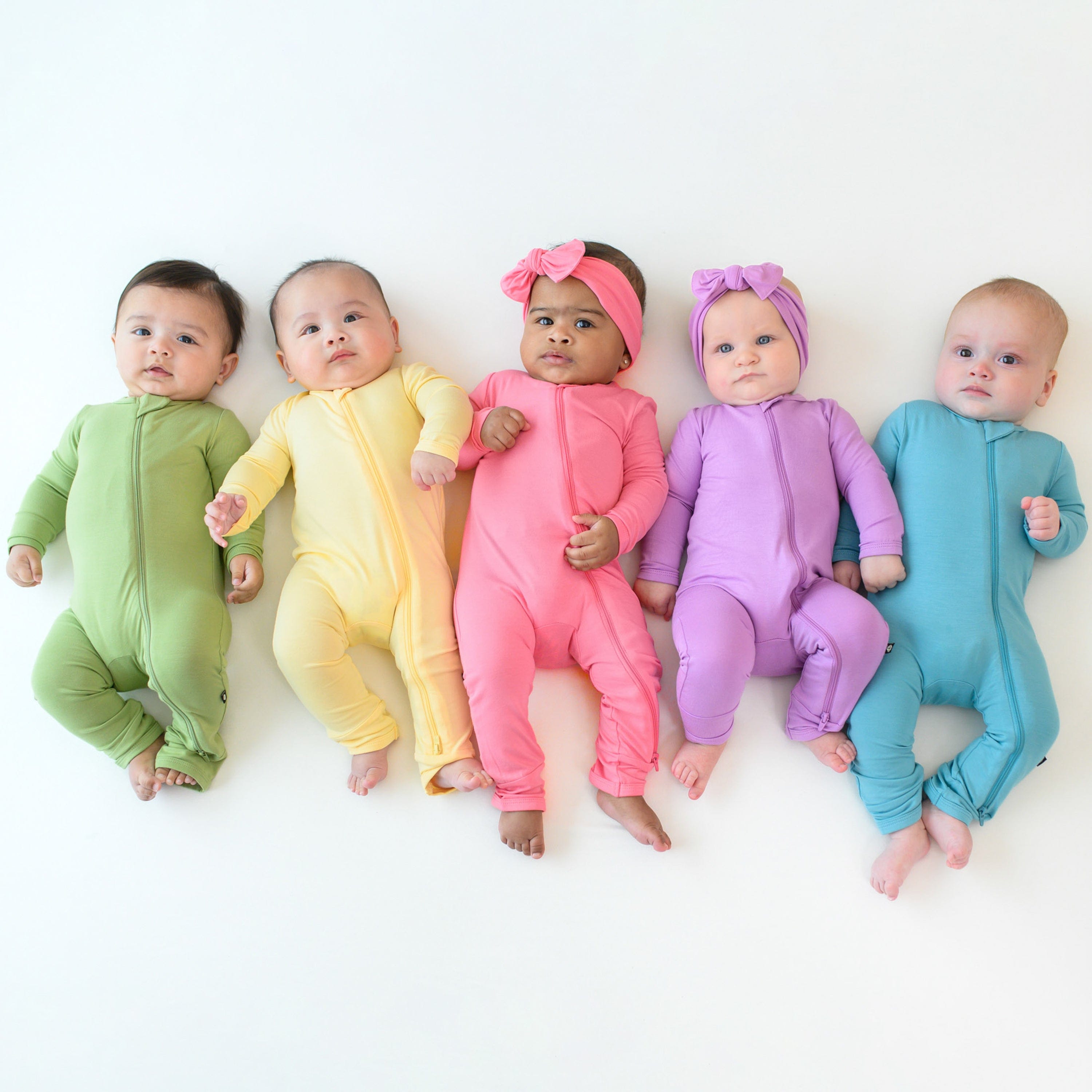 zippered rompers in hawaii inspired spring solids on a group of 5 babies