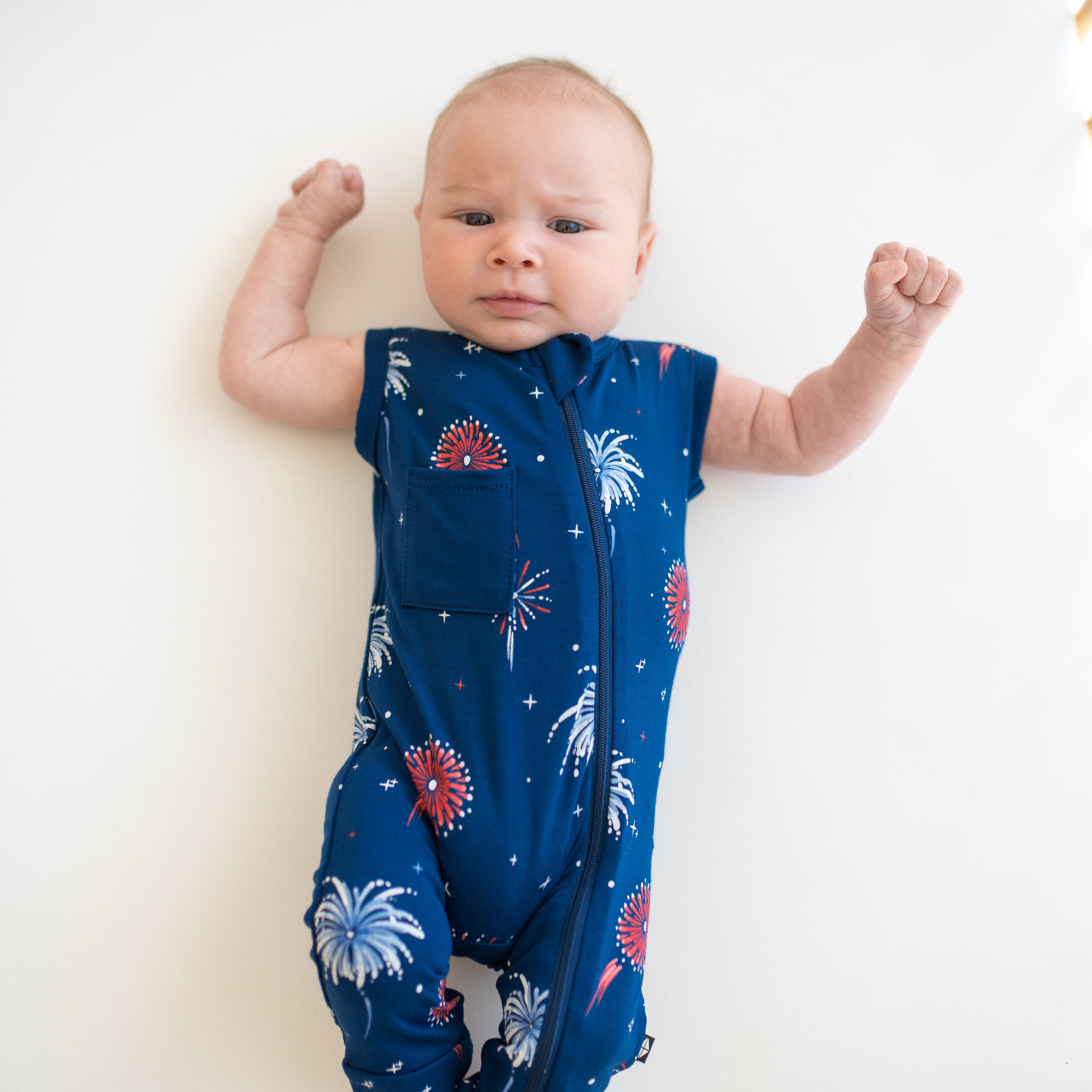Close up of baby wearing Zippered Sleeveless Romper in Celebration