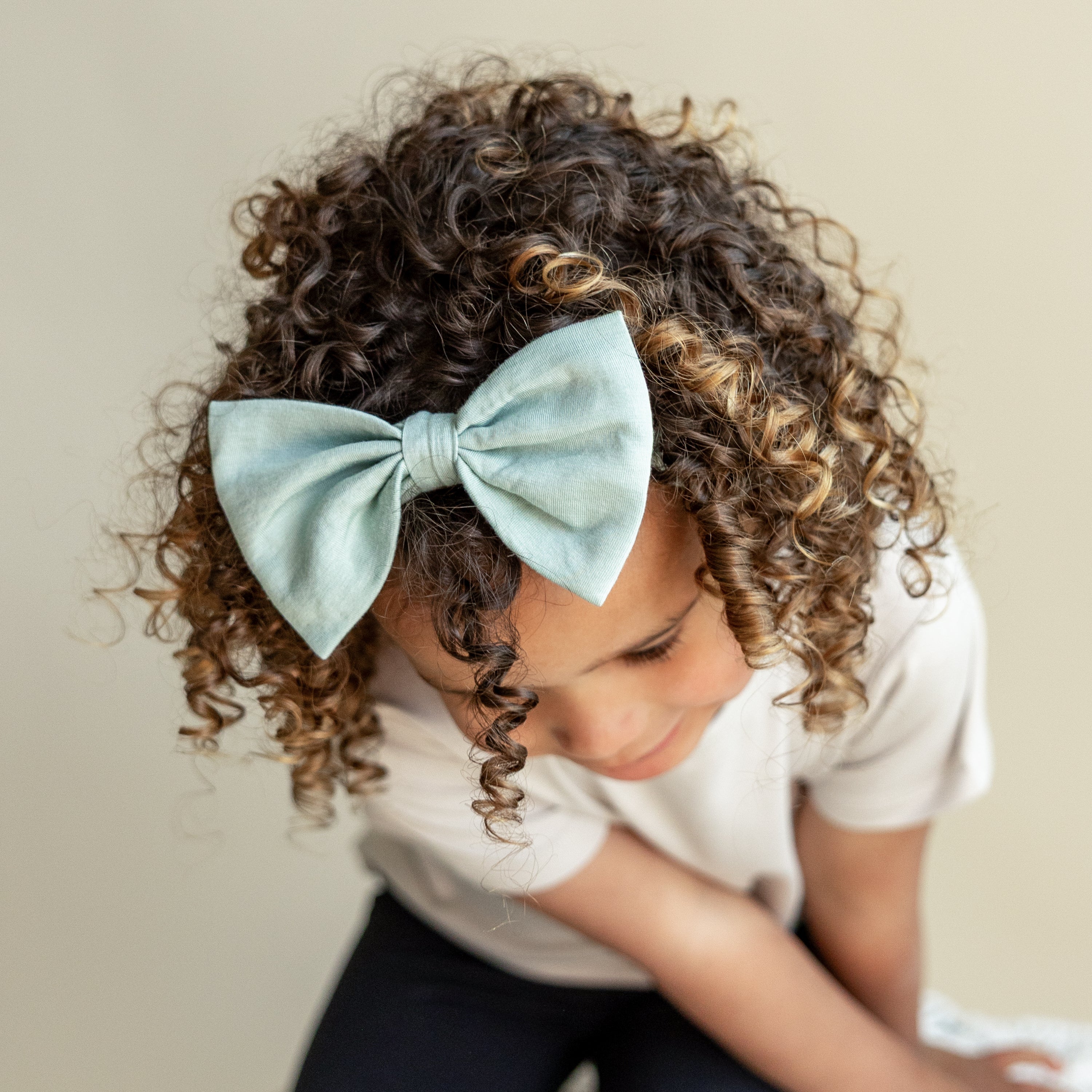 Toddler wearing Bamboo Bow Headband in Sage