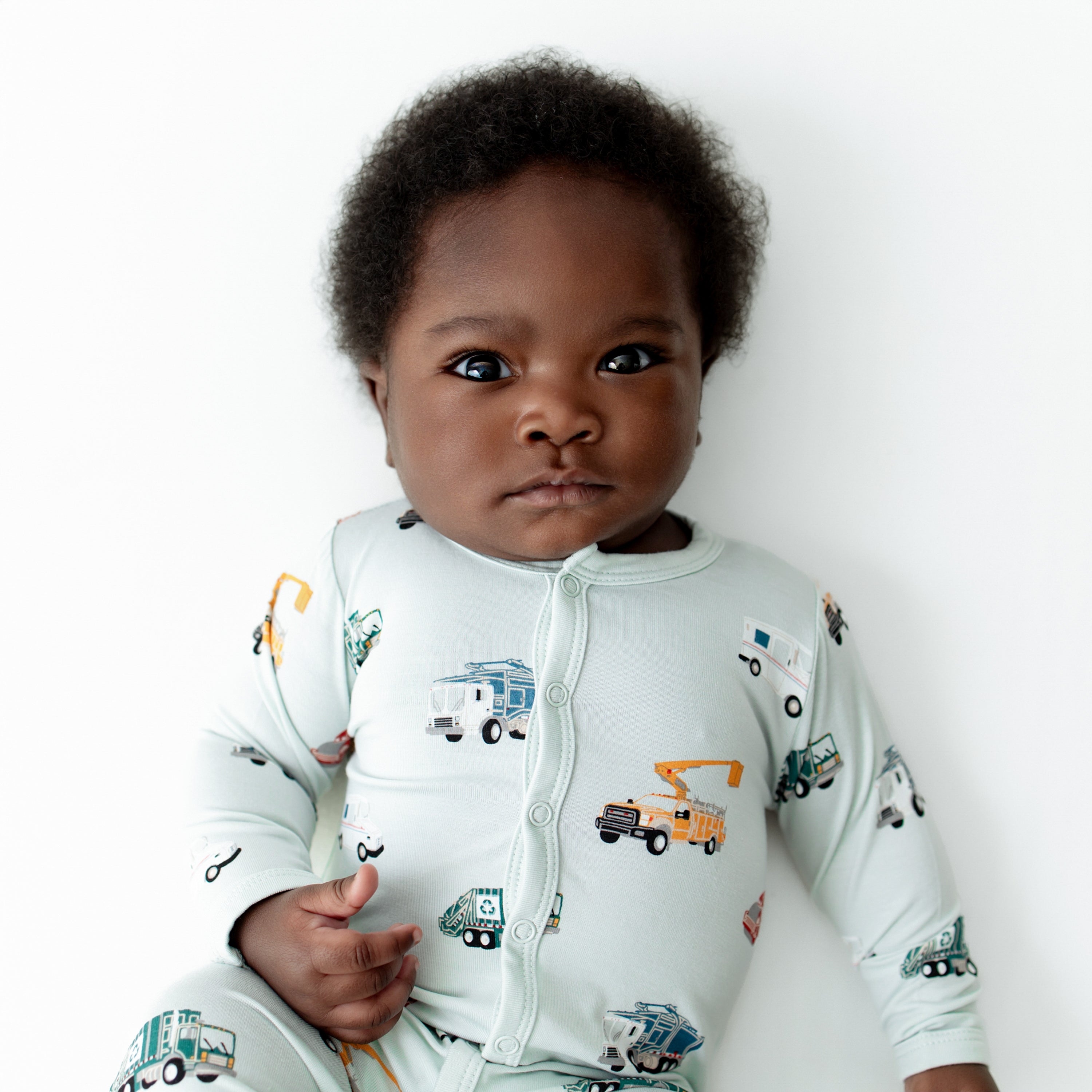 Close up of infant wearing the Romper in City Vehicles