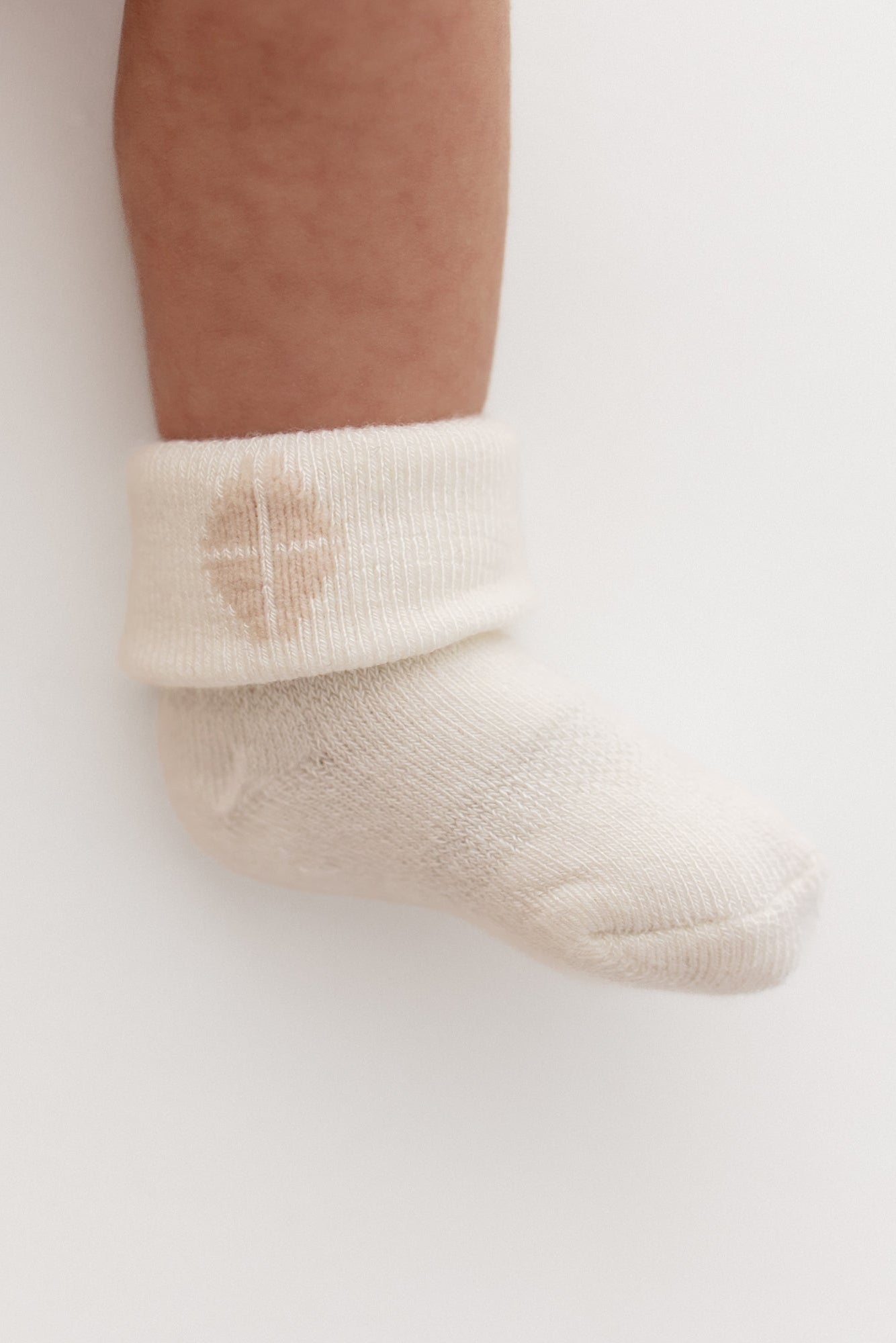Baby wearing white infant socks