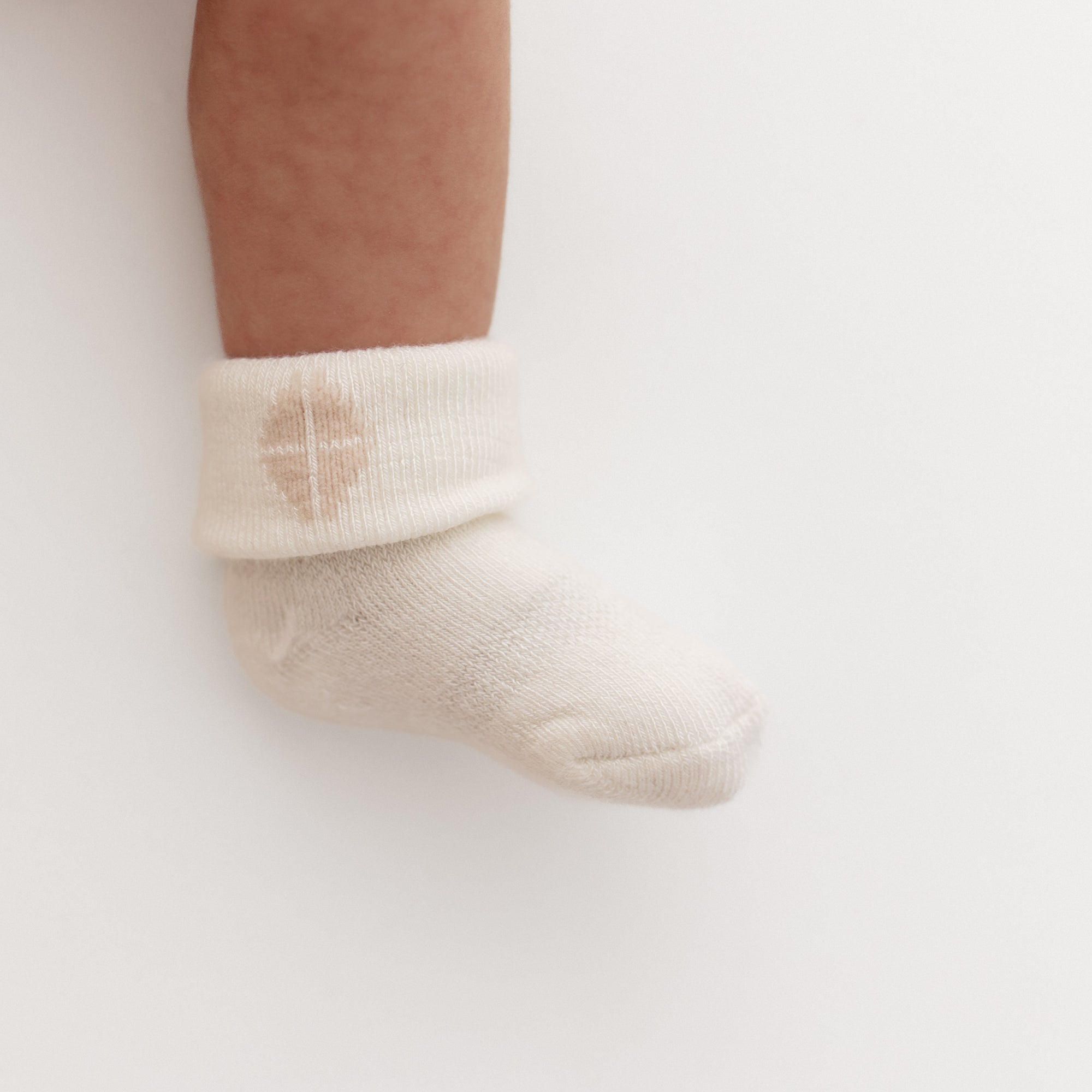 Baby wearing white infant socks