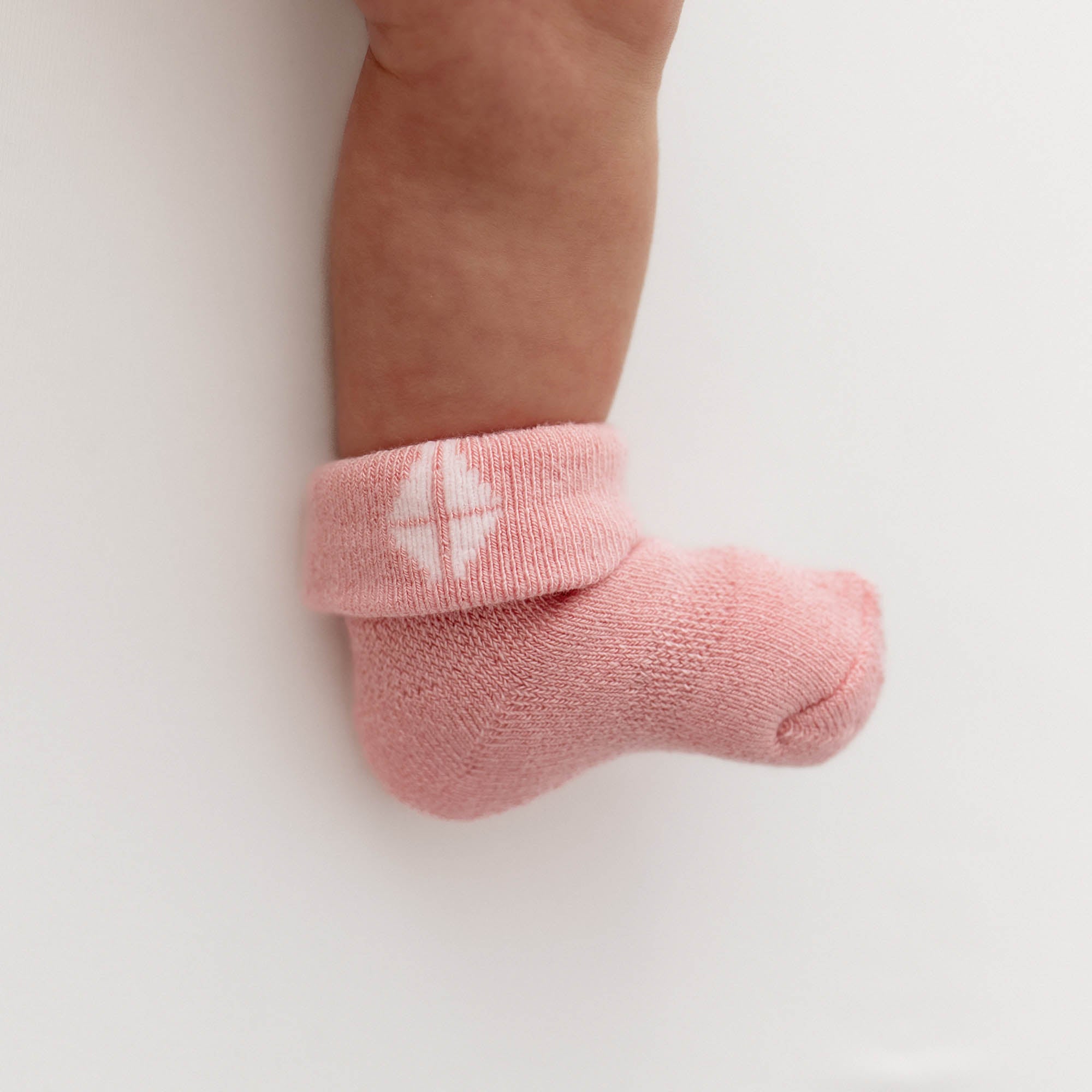 Crepe pink plush infant socks on baby