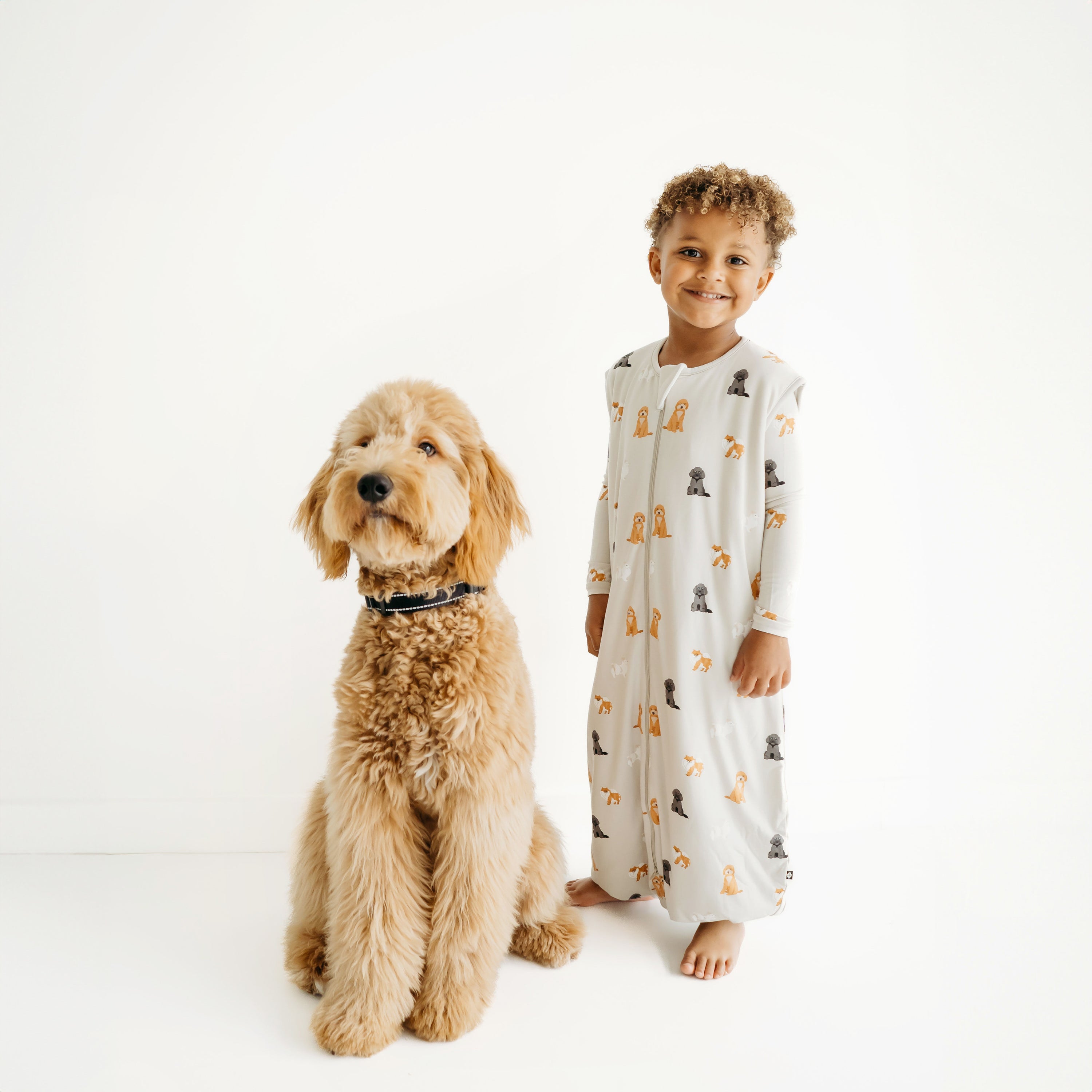 Boy modeling Sleep Bag Walker in Fluffy Dog 1.0 next to a real dog