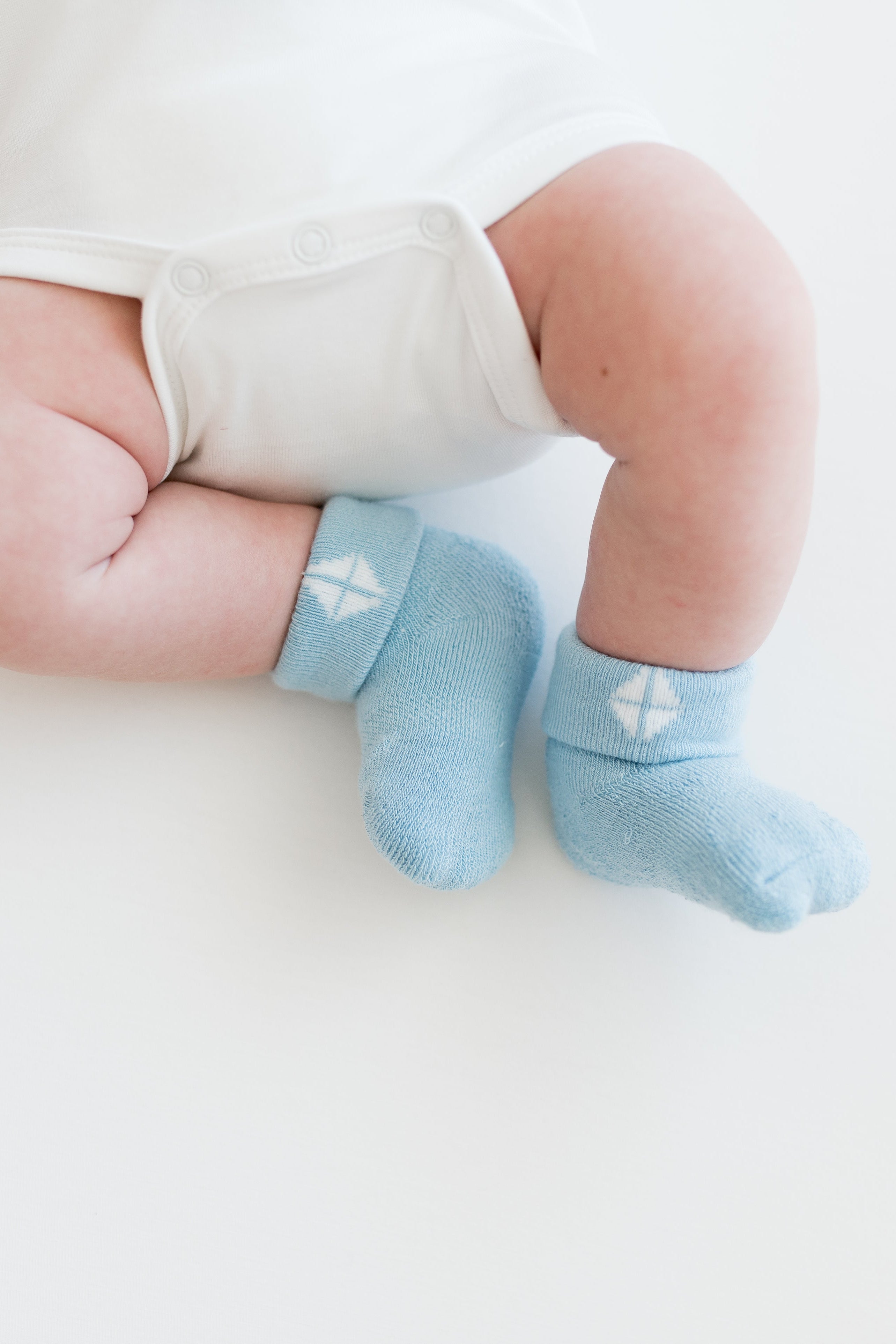 Baby wearing soft bamboo infant socks in blue
