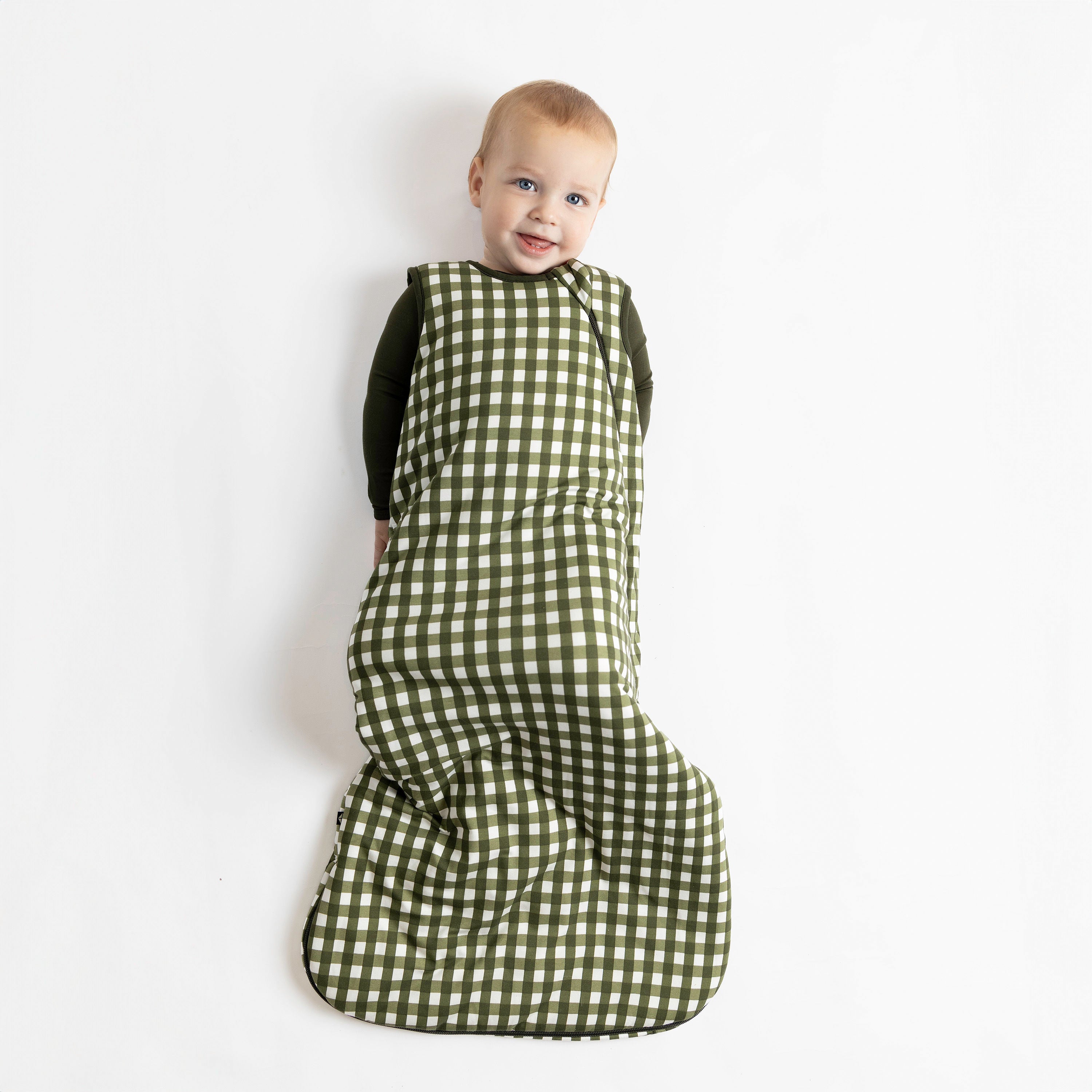 Toddler wearing bamboo TOG 2.5 Sleep Bag in Gingham Fir over dark green pjs