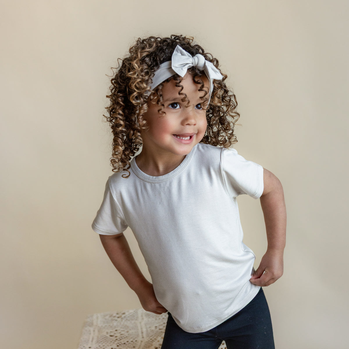 Toddler wearing Basic Tee in Oat with Matching Knotted Bow