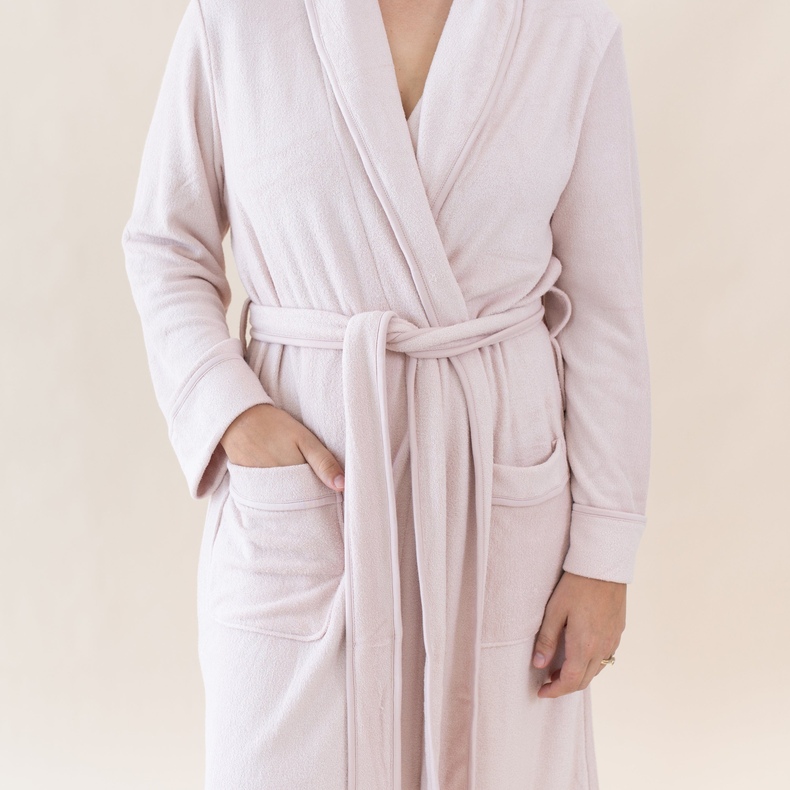 Woman wearing Kyte Baby Adult Robe with front patch pockets in Blush